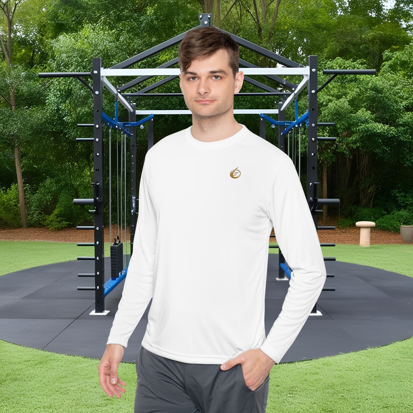 Man standing in front of outdoor fitness equipment in a 'EssenceInnoCreate' T-shirt with greenery in the background