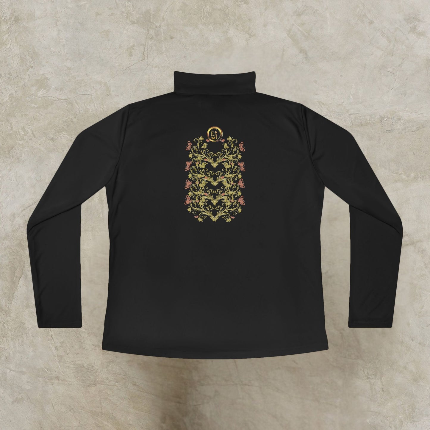 Black long-sleeve shirt with an Essence Innovation Bohemian Butterfly floral emblem on a textured beige background