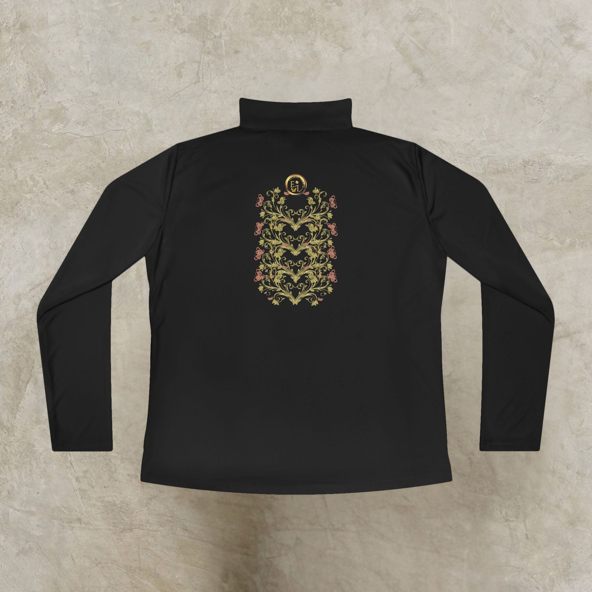 Black long-sleeve shirt with an Essence Innovation Bohemian Butterfly floral emblem on a textured beige background