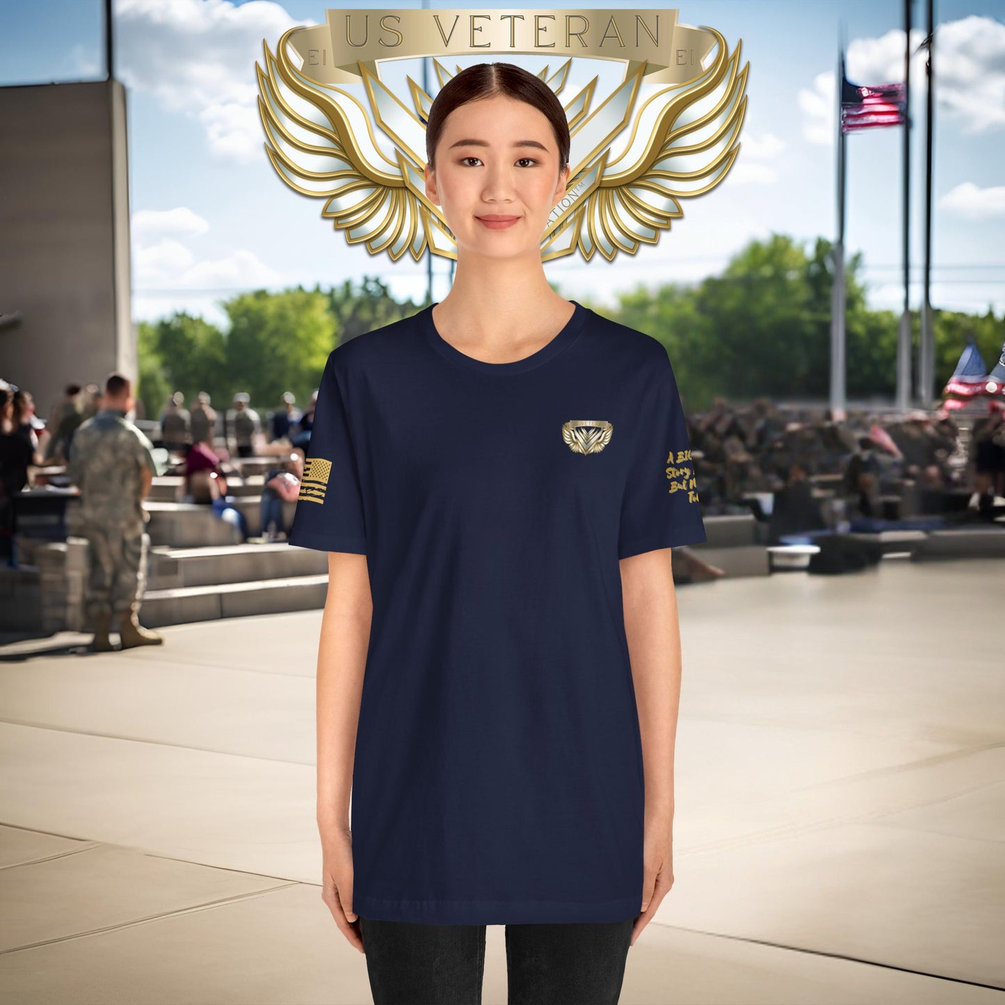 Person wearing a black t-shirt with gold emblem and 'US Veteran' text, standing in front of a crowd.