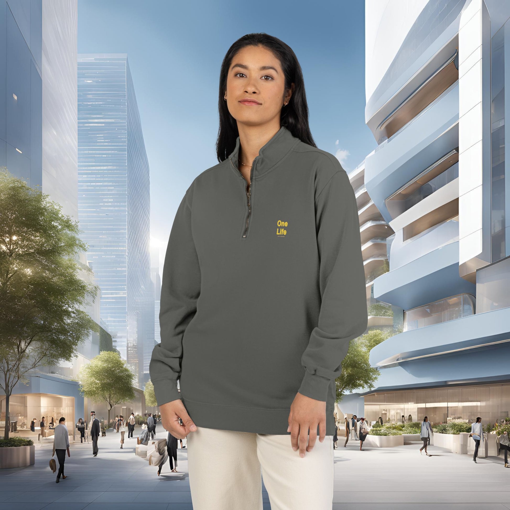 Person wearing a gray sweatshirt with a One Life logo in an urban setting