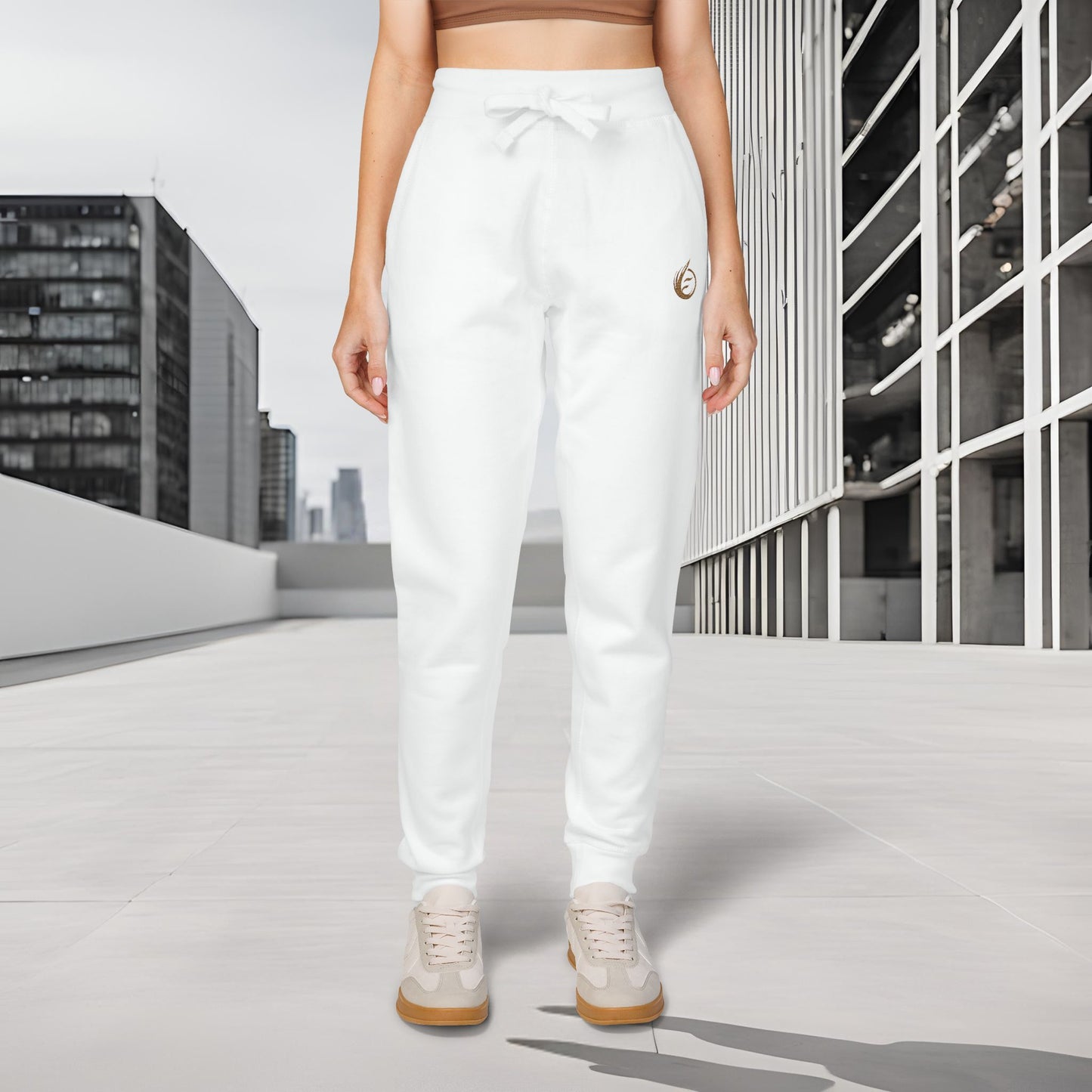 Person wearing white 'EssenceInnoCreate' Quiet Resolve sweatpants standing in an urban setting with modern buildings.