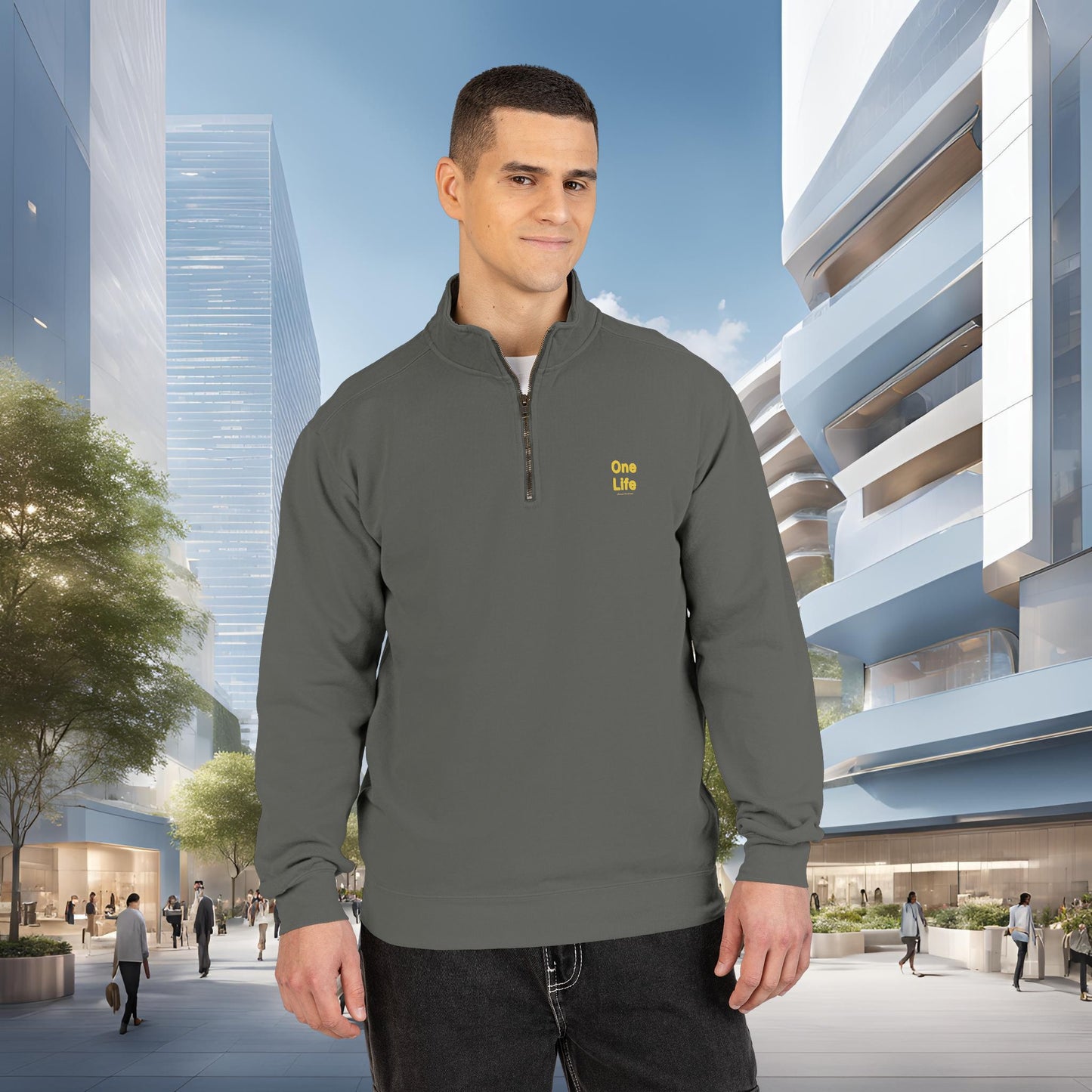 Man wearing a gray pullover with a One Life logo in an urban setting