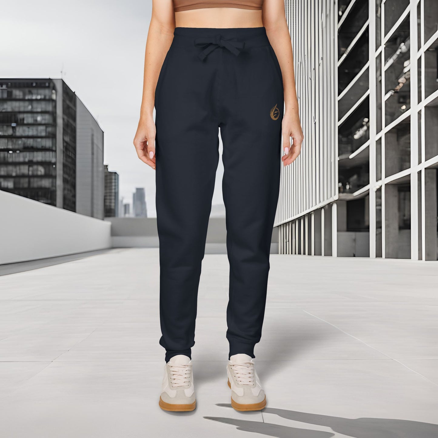 Person wearing black 'EssenceInnoCreate' Quiet Resolve jogger pants with a logo in an urban setting