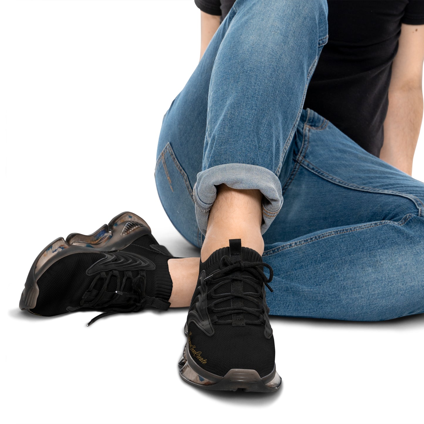 Person wearing black 'EssenceInnoCreate' sneakers with colorful accents on a white background