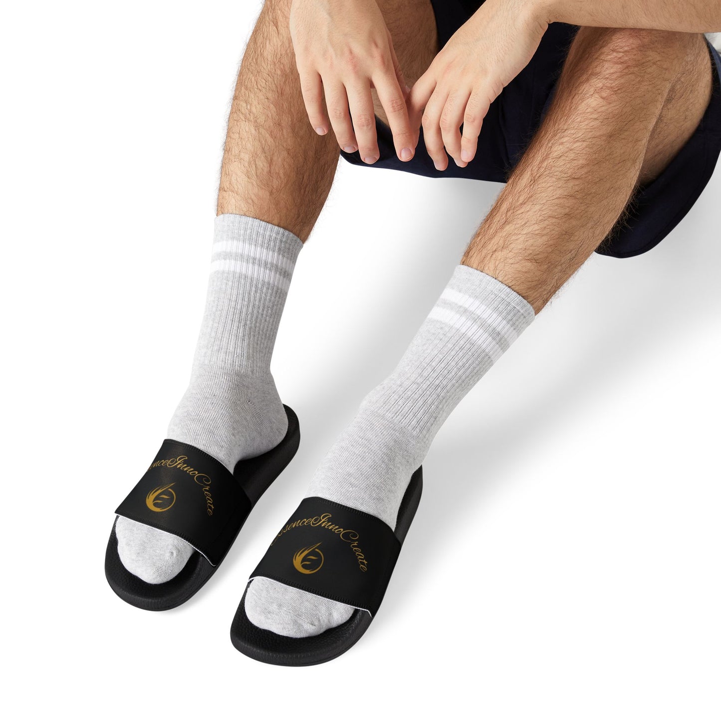 Person wearing Supreme EssenceInnoCreate slides and white socks on a white background