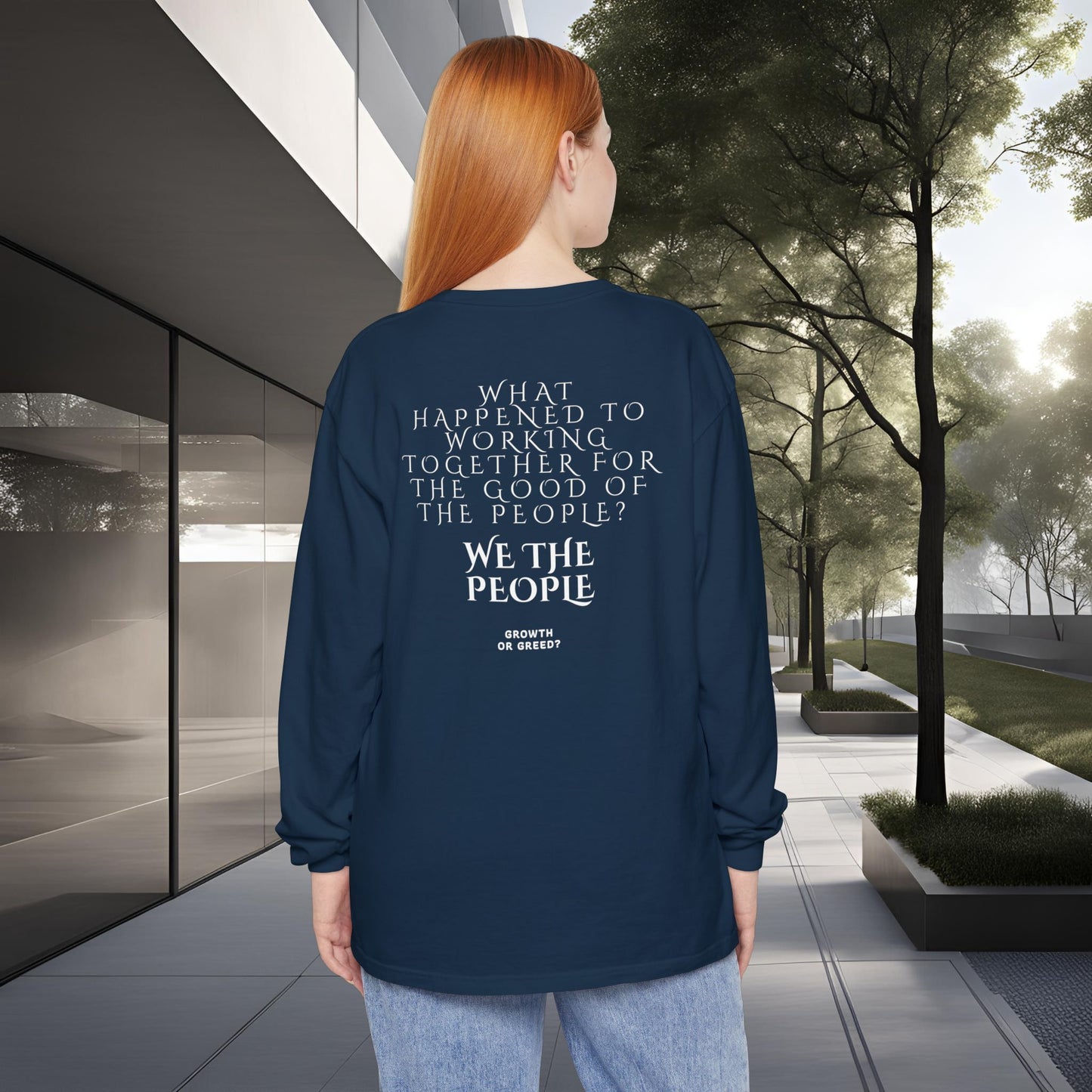 Person wearing a blue long-sleeve EssenceInnoCreate Quiet Resolve shirt with text in an urban setting