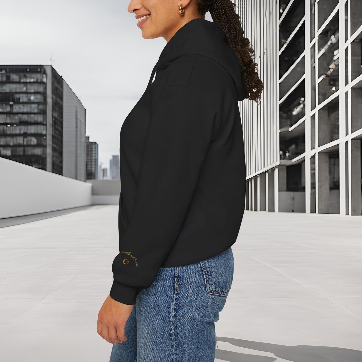 Person wearing a black 'EssenceInnoCreate' hoodie with a cityscape background