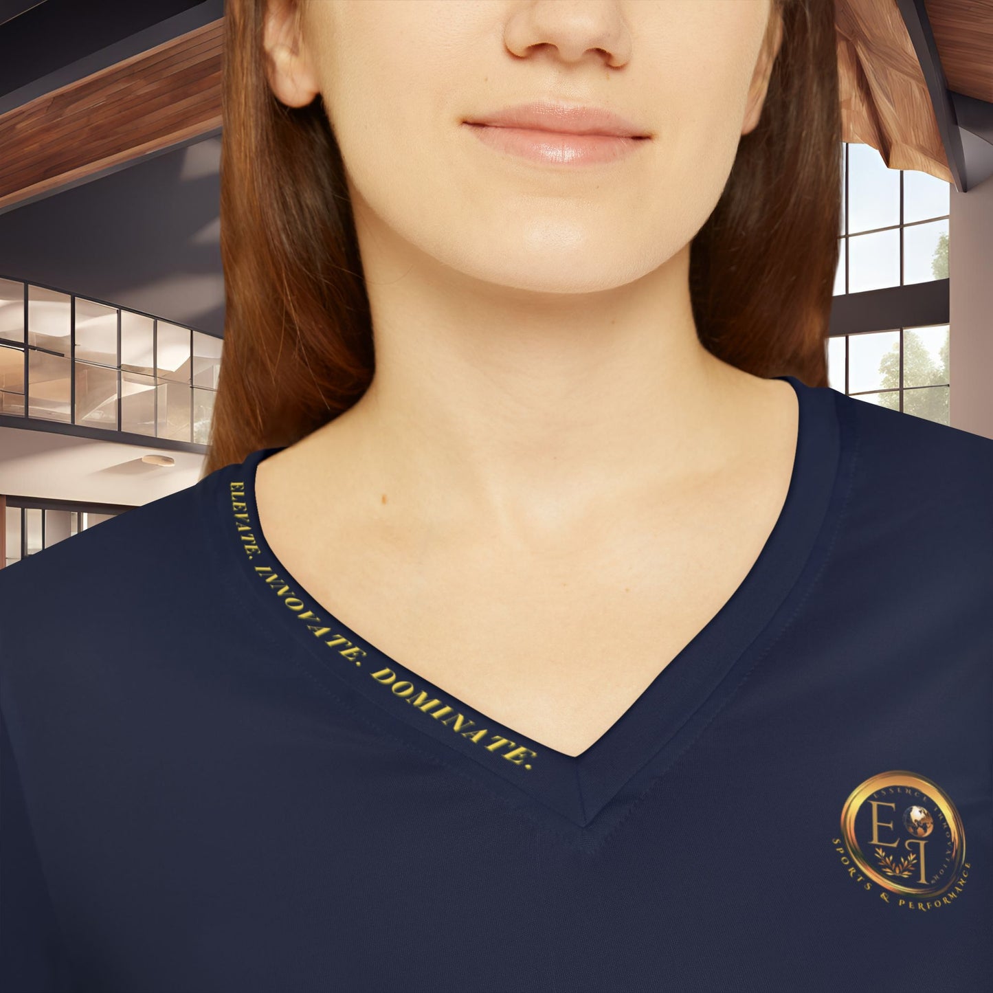 Navy blue shirt with gold text and Essence Innovation logo worn by a person indoors.
