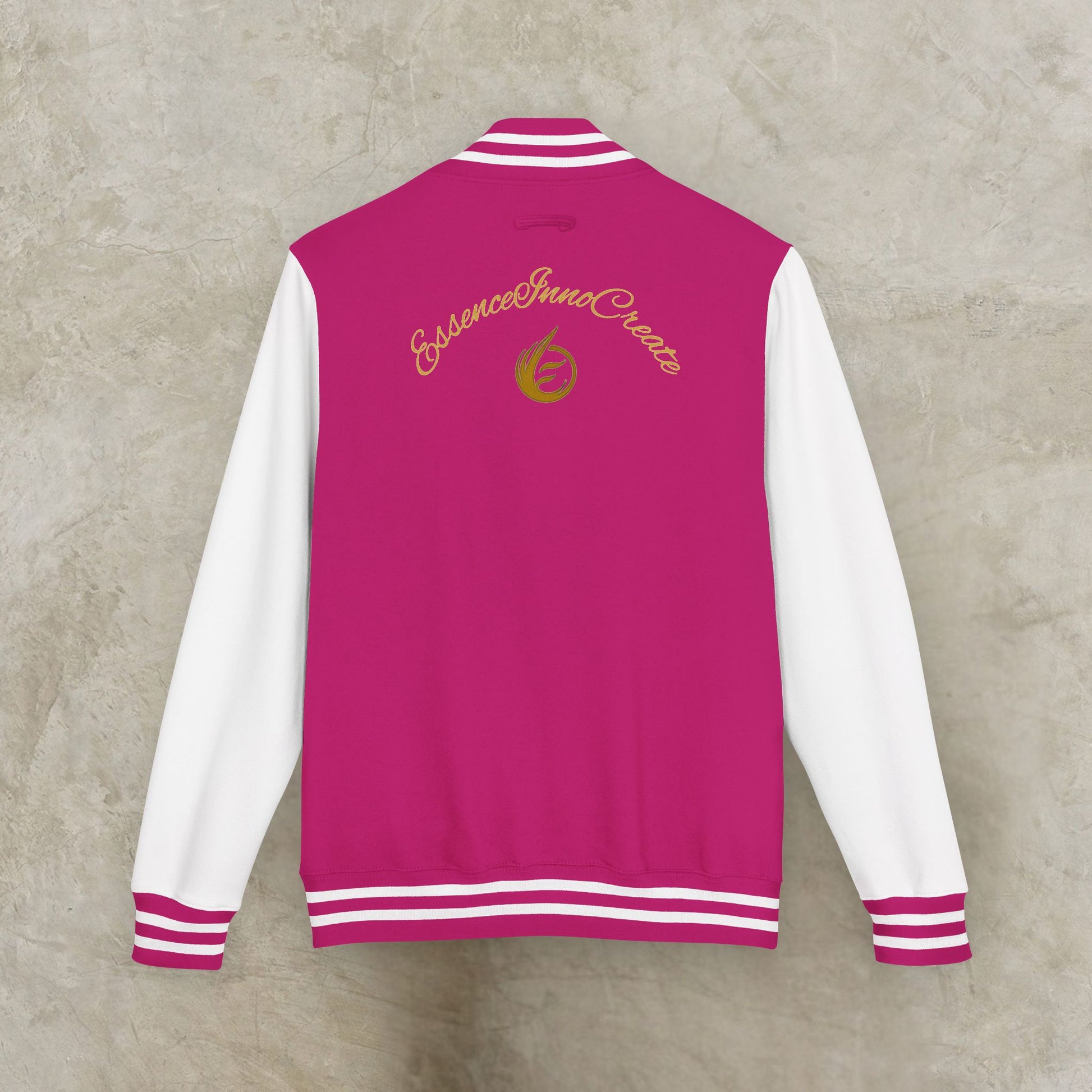 Pink and white varsity jacket with 'EssenceInnoCreate' logo on a textured beige background
