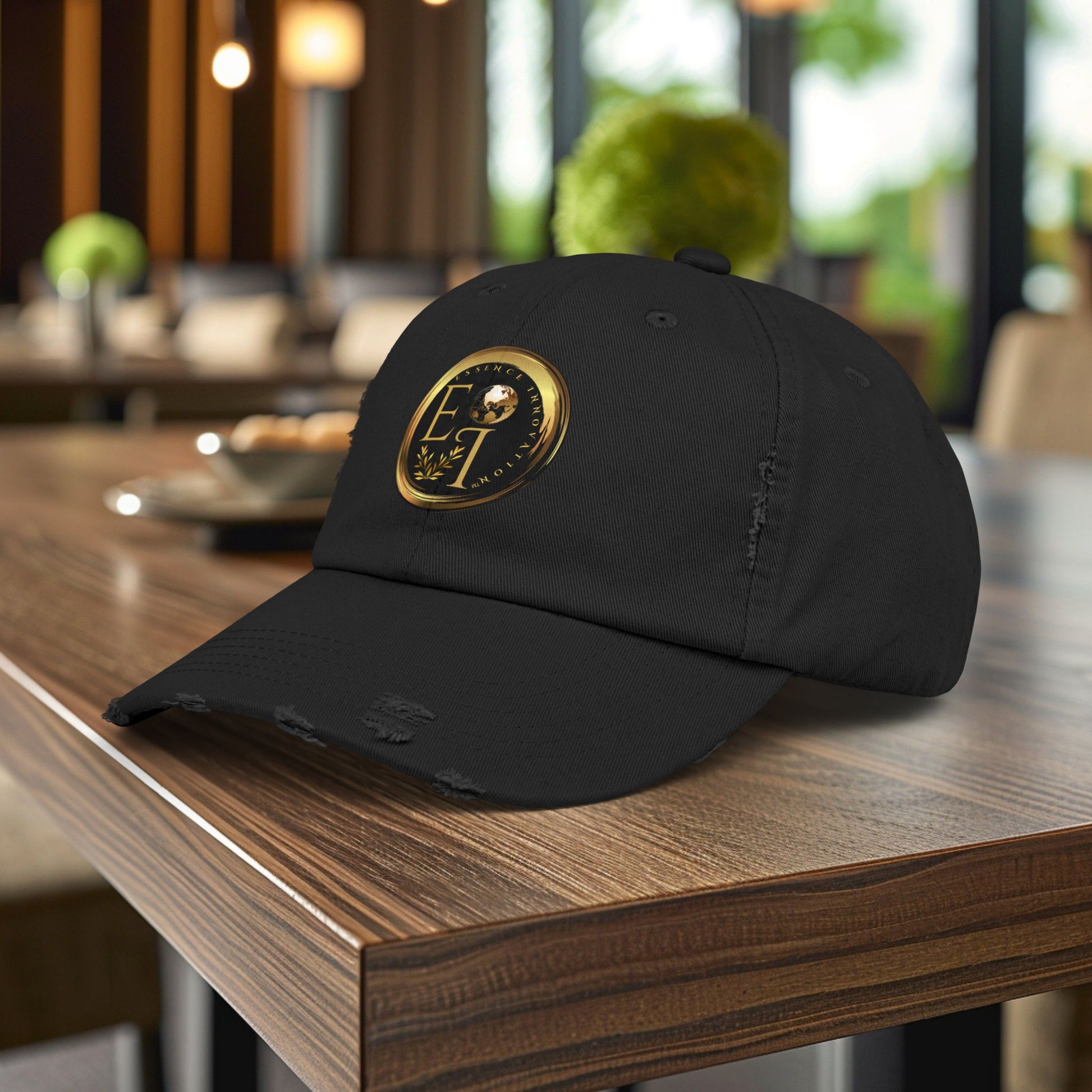 Black Essence Innovation cap with a gold emblem on a wooden table in a blurred indoor setting