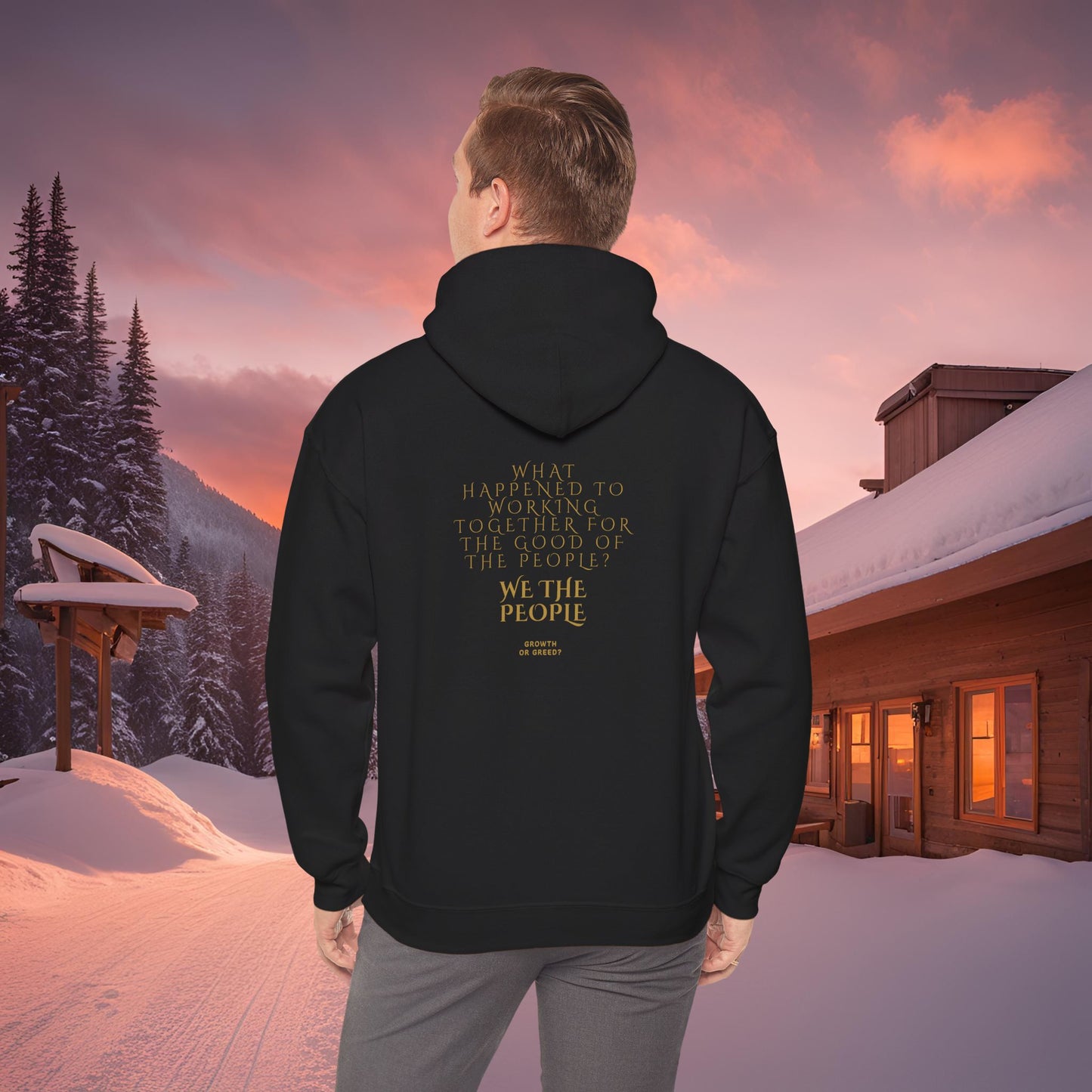 Person wearing a black EssenceInnoCreate Quiet Resolve hoodie with text in a snowy landscape with a cabin.