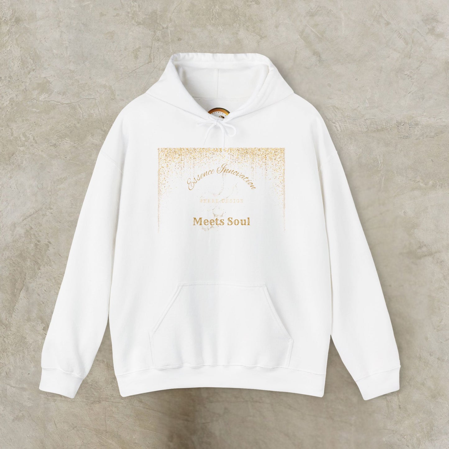 White hoodie with gold Essence Innovation 'Design Meets Soul' text on a beige background