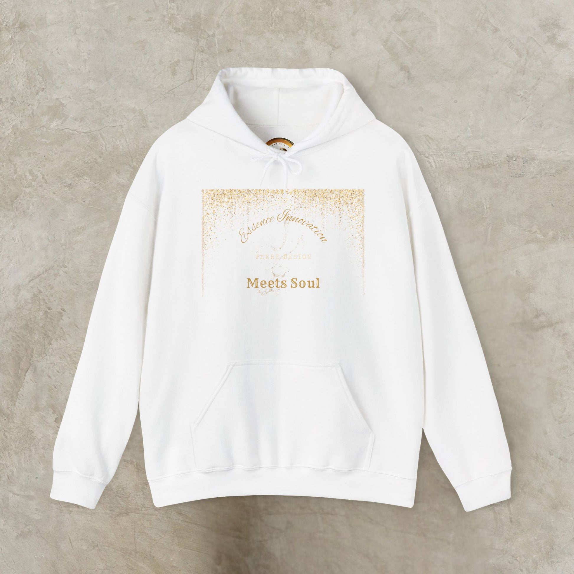 White hoodie with gold Essence Innovation 'Design Meets Soul' text on a beige background