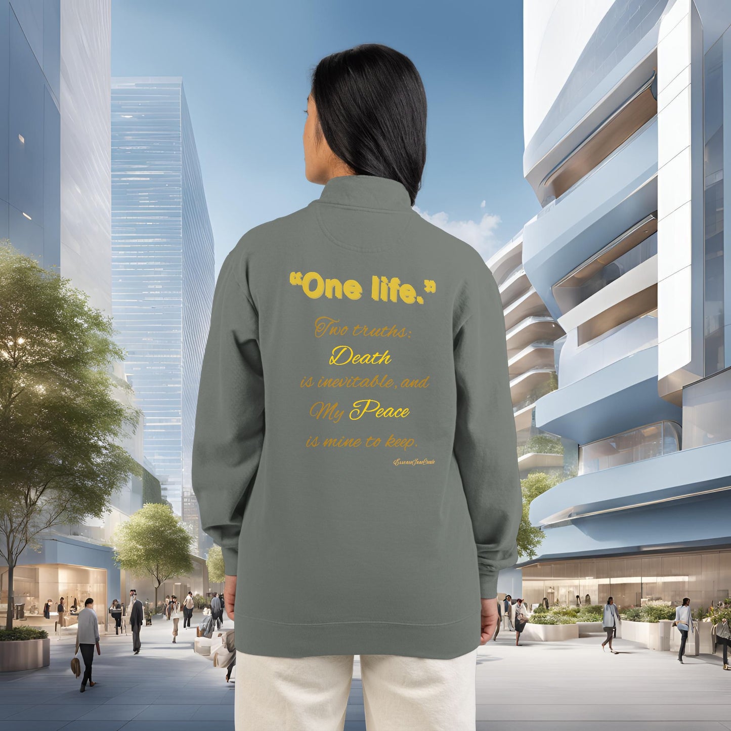 Person wearing a gray jacket with One Life text on the back in an urban setting