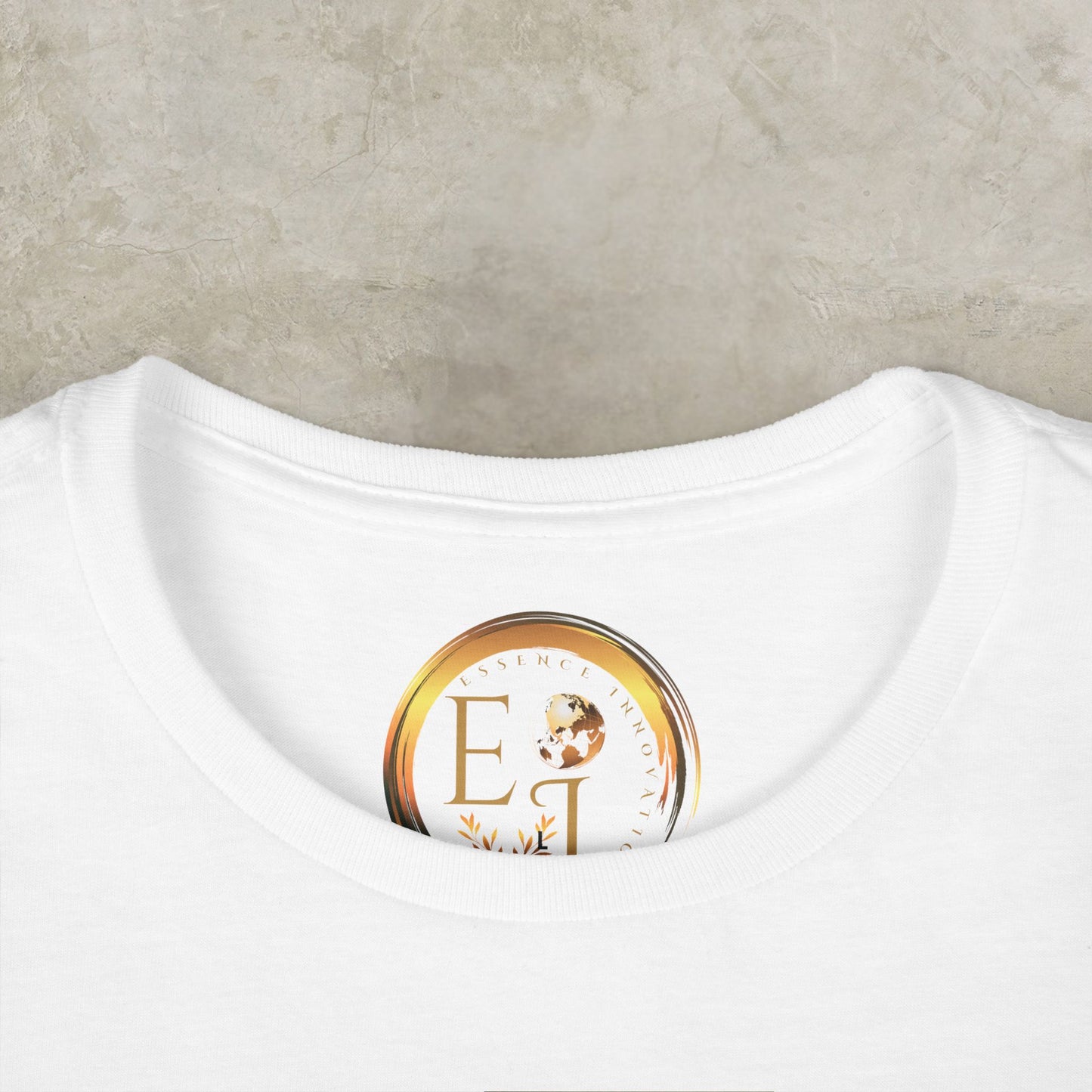 White t-shirt with a gold and brown Essence Innovation logo on a beige background