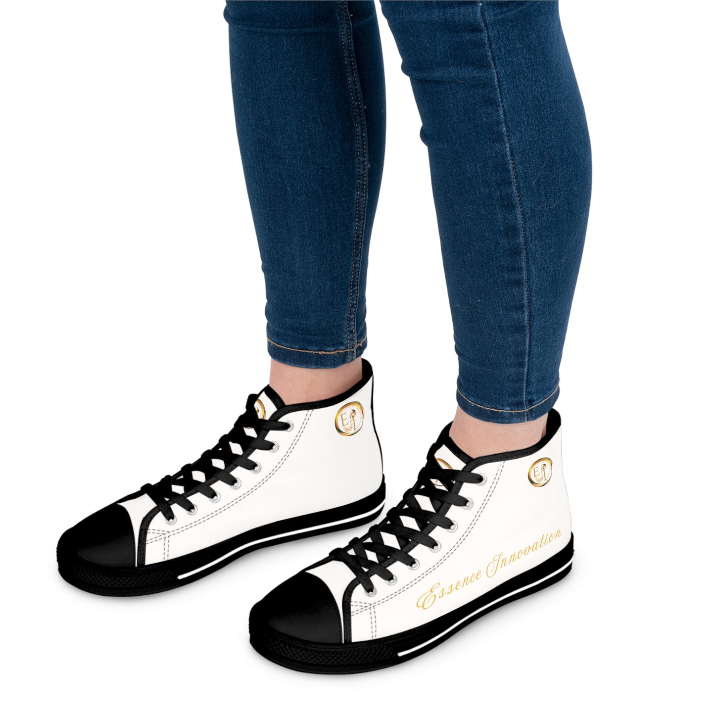 White high-top 'Essence Innovation' sneakers with black soles and gold accents worn with blue jeans on a white background