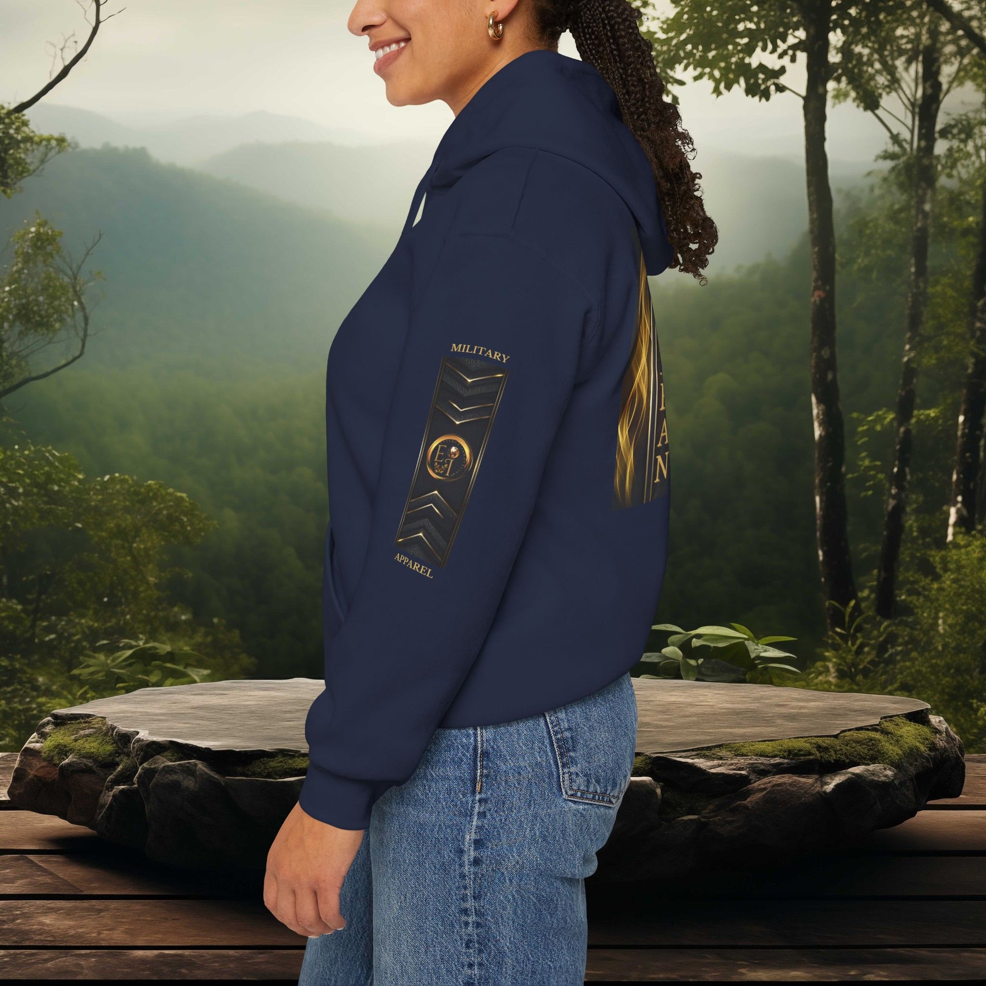 Person wearing a navy Essence Innovation hoodie with a logo in a forest setting