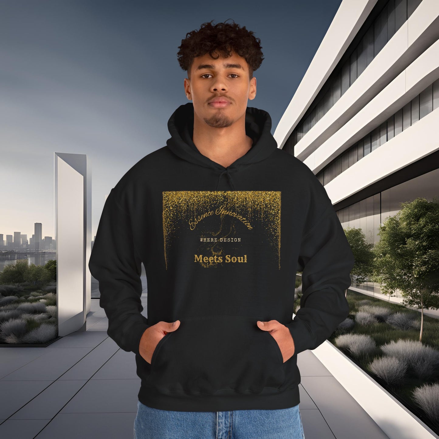 Person wearing a black hoodie with gold Essence Innovation 'Design Meets Soul' text in an urban setting