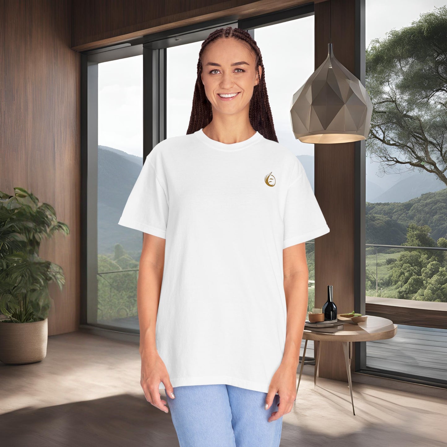 Woman wearing a white t-shirt with a 'EssenceInnoCreate' logo in a modern room with large windows.
