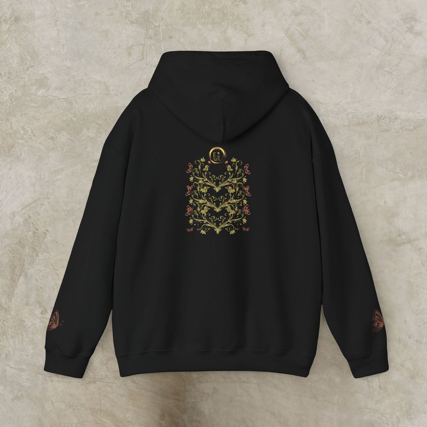 Navy blue hoodie with floral Essence Innovation Bohemian Butterfly Crest design on the back against a beige background