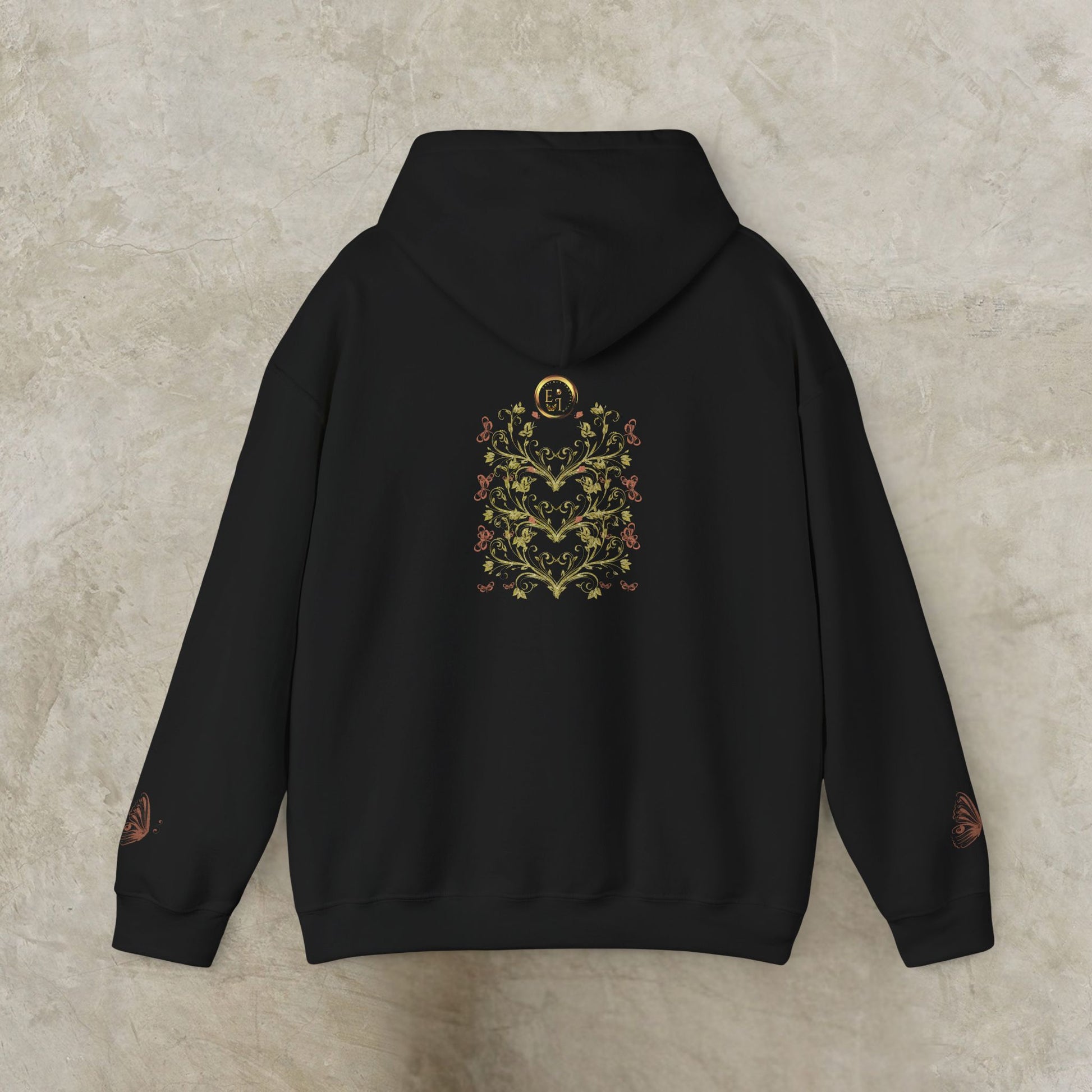 Navy blue hoodie with floral Essence Innovation Bohemian Butterfly Crest design on the back against a beige background