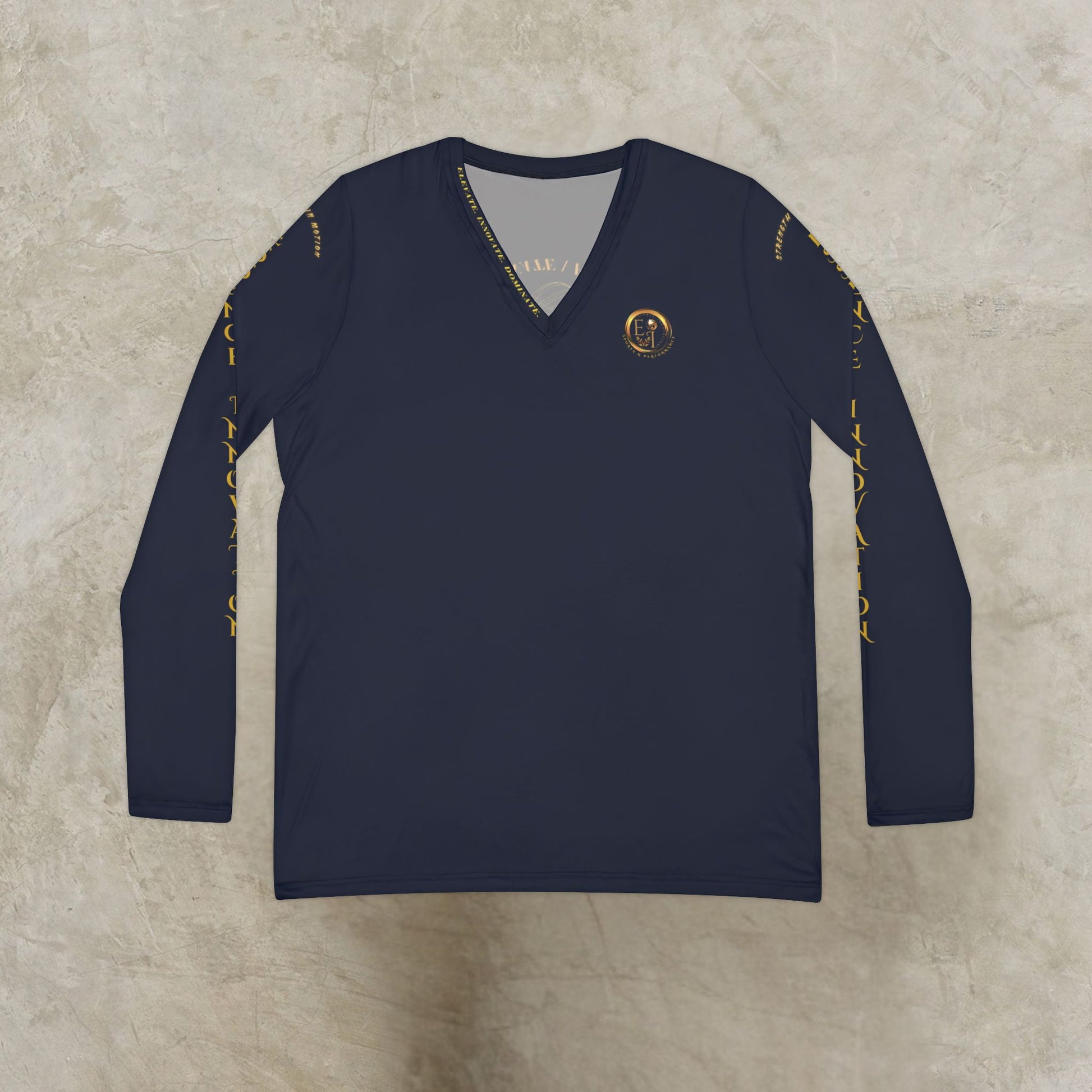 Navy long-sleeve Essence Innovation shirt with gold accents on a textured beige background