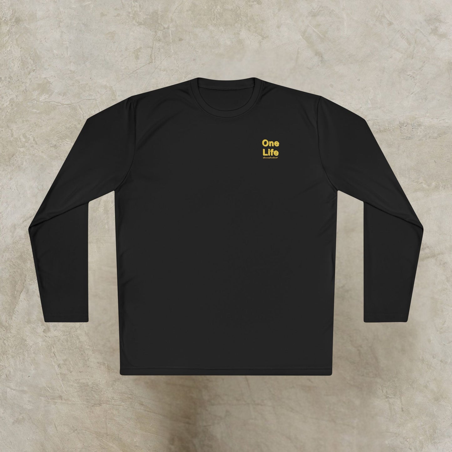 Black long-sleeve shirt with 'One Life' text on a beige surface
