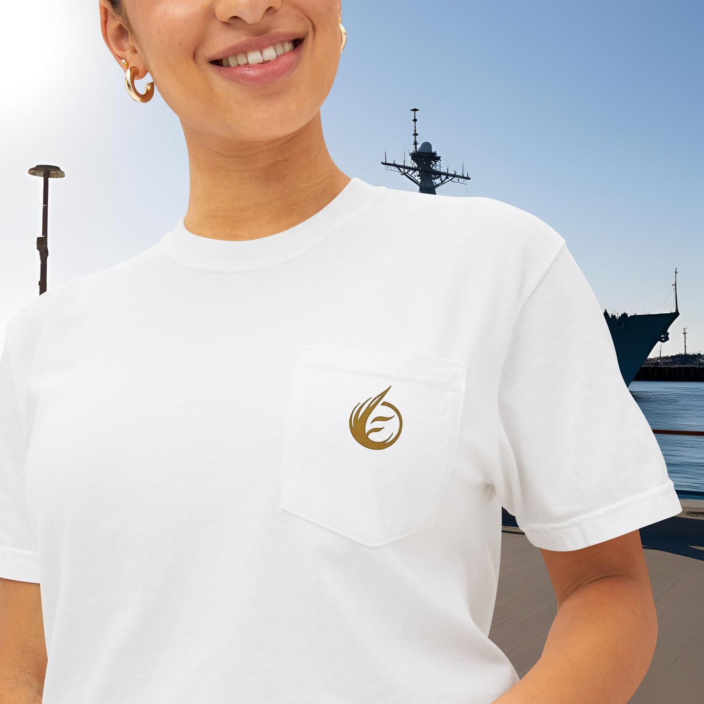 Person wearing a white t-shirt with 'EssenceInnoCreate' logo, with a ship in the background