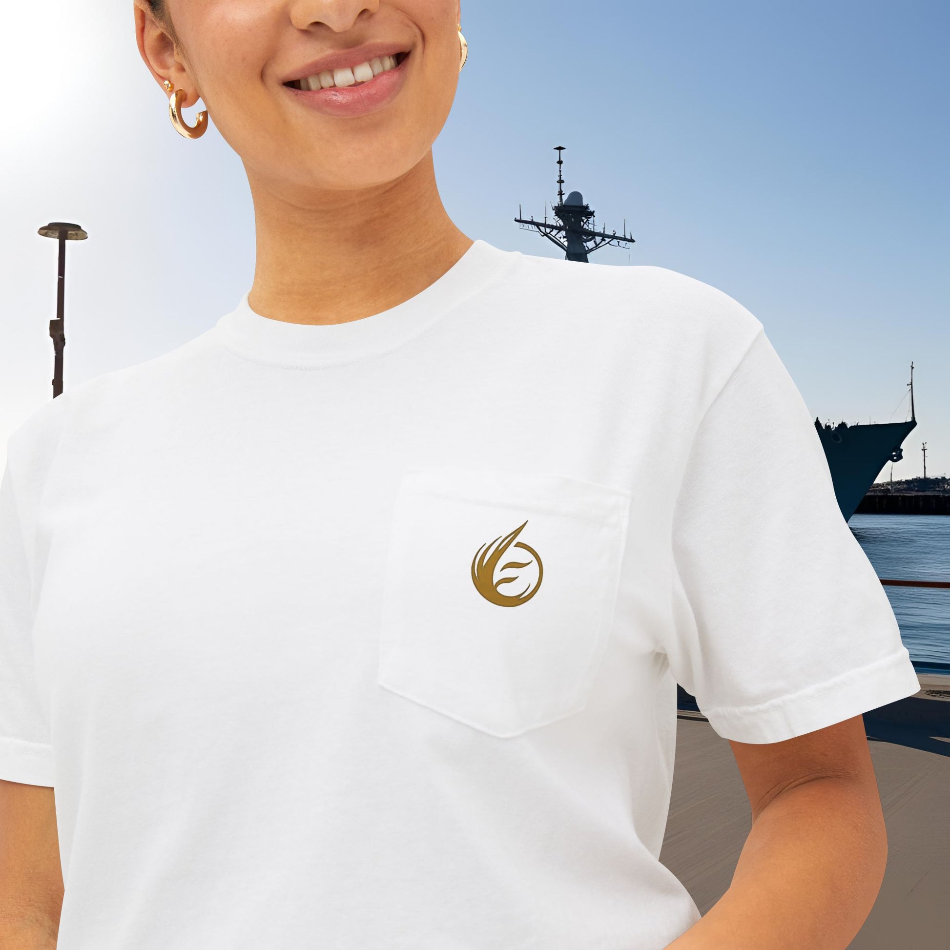 Person wearing a white t-shirt with 'EssenceInnoCreate' logo, with a ship in the background