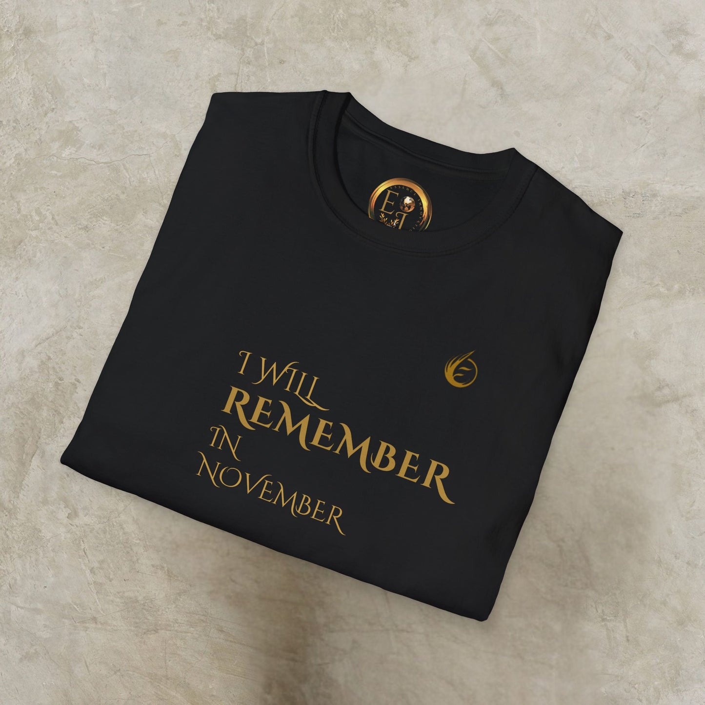 Folded black EssenceInnoCreate Quiet Resolve sweatshirt with gold text and logo on a beige surface