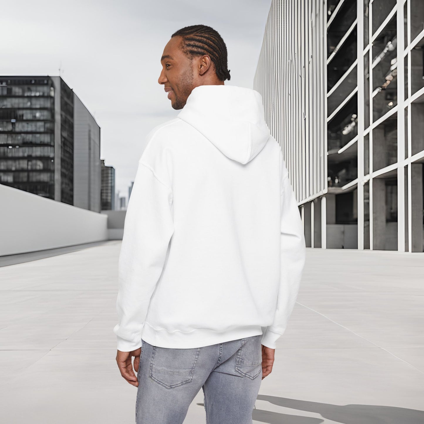 Man wearing a white Essence Innovation 'One Life' hoodie standing on a rooftop with cityscape in the background