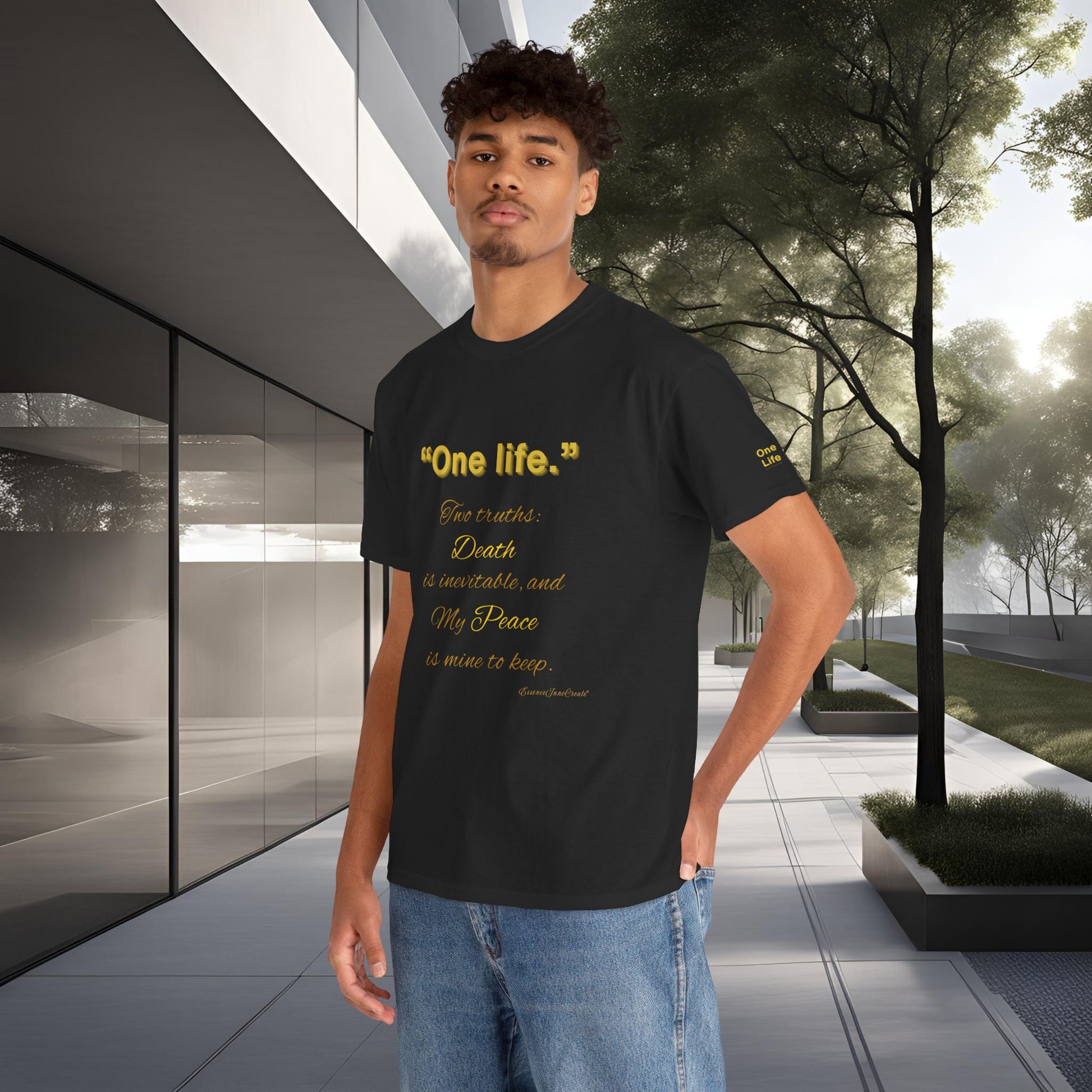 Person wearing a black t-shirt with yellow One Life text in an outdoor setting
