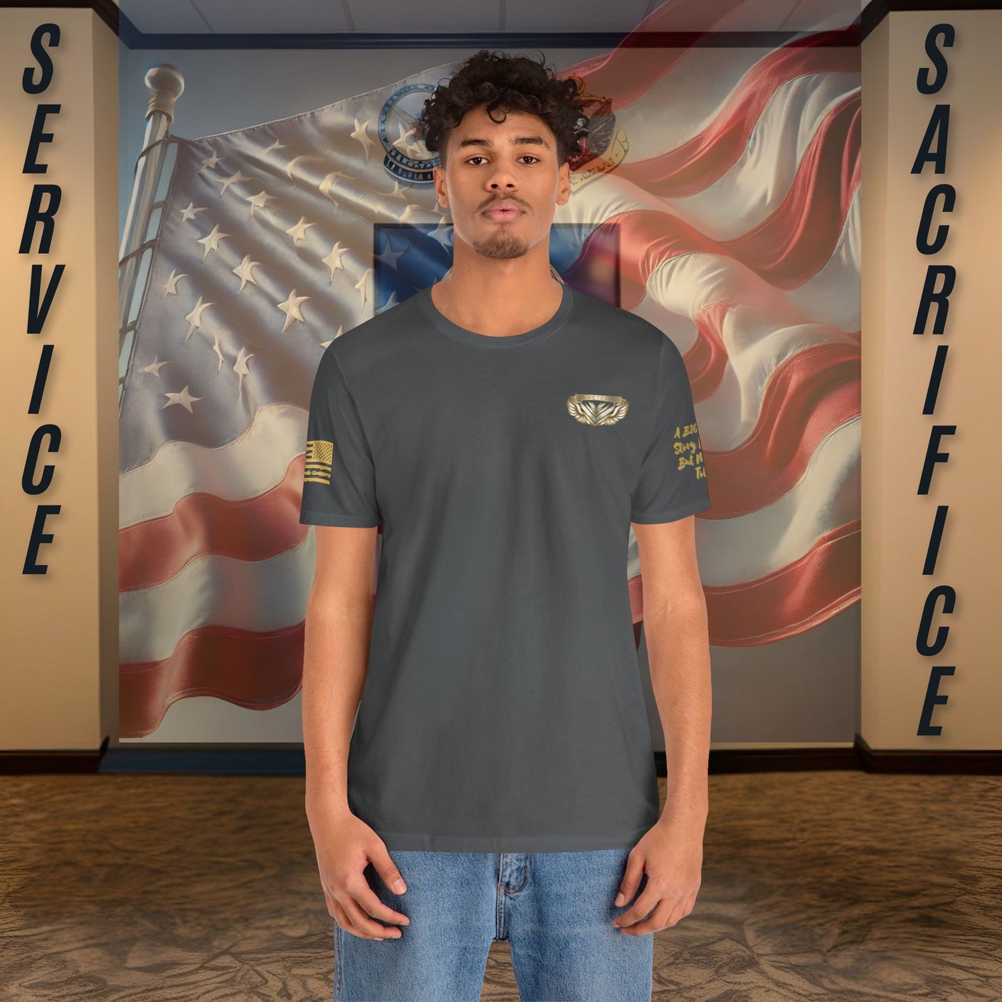 Person wearing a gray t-shirt with a logo in front of an American flag and 'Service' and 'Sacrifice' text.