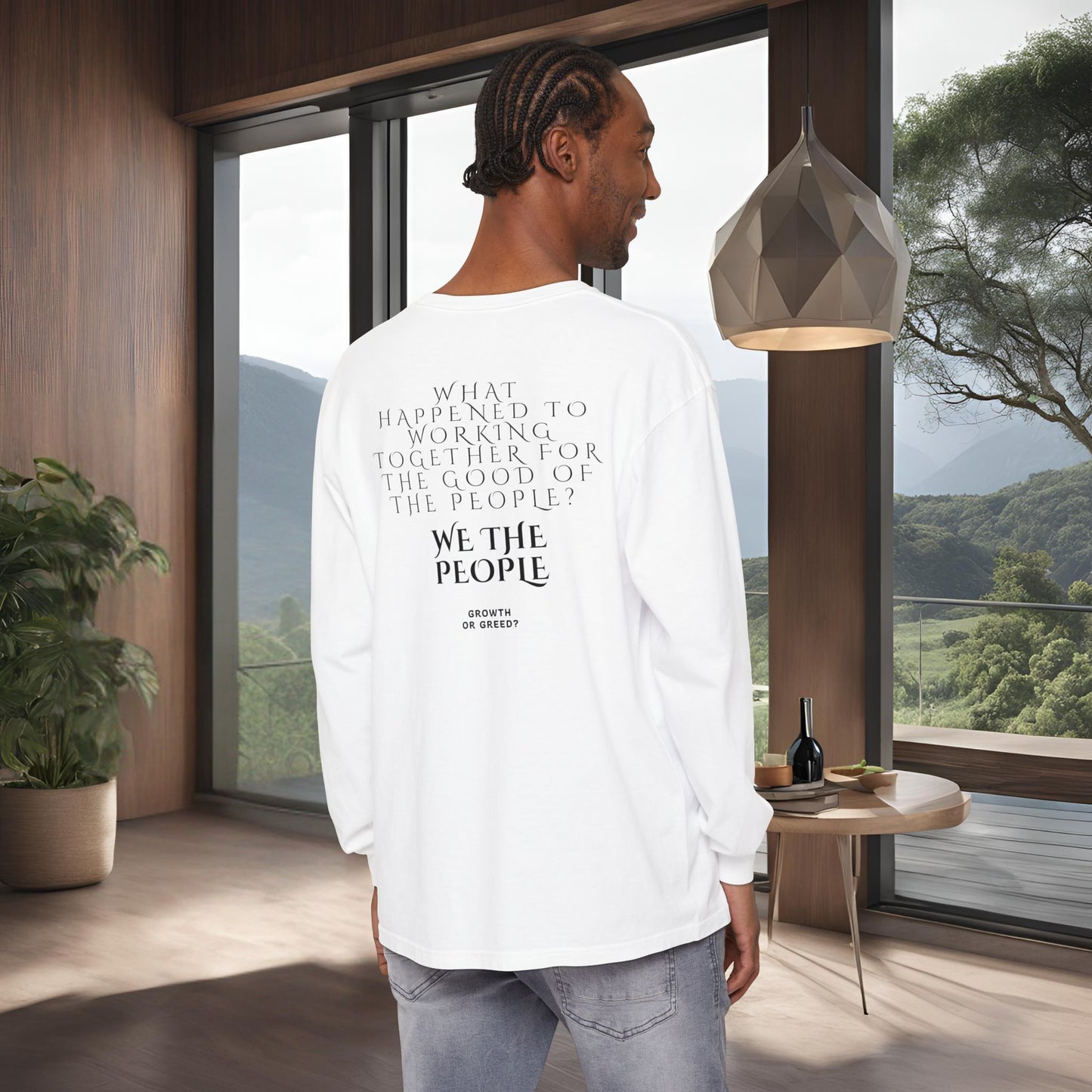 Man wearing a white long-sleeve shirt with EssenceInnoCreate Quiet Resolve text in a modern room with large windows.