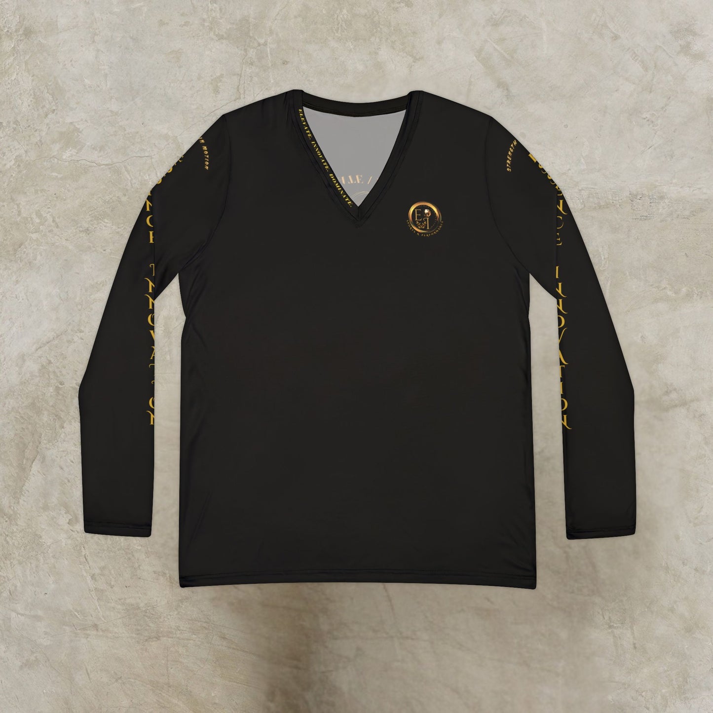 Essence Innovation Seek More Black long-sleeve shirt with gold accents on a textured beige background