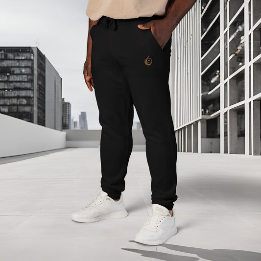 Person wearing black 'EssenceInnoCreate' Quiet Resolve jogger pants and white sneakers on a rooftop with cityscape background