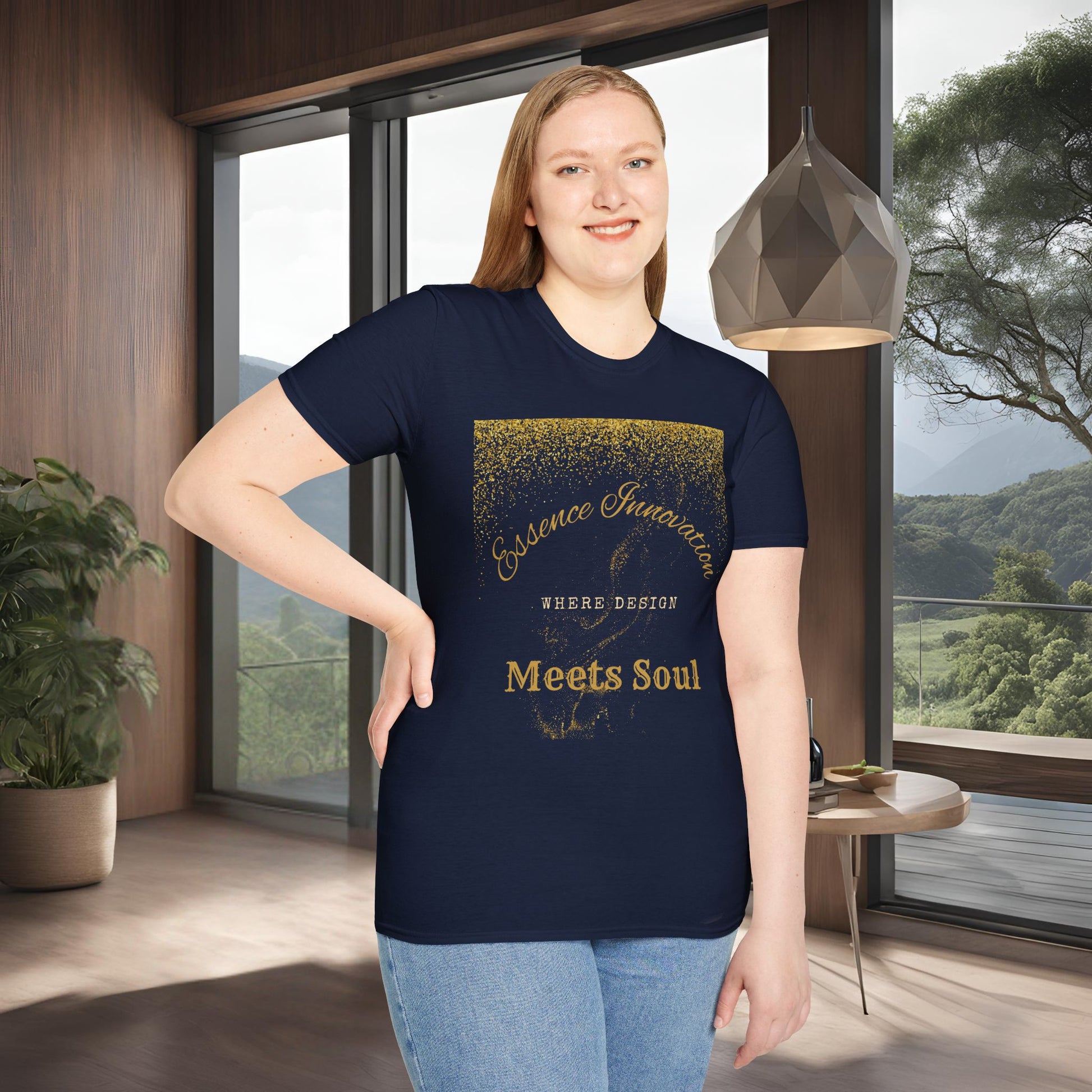 Person wearing a navy blue t-shirt with gold Essence Innovation 'Design Meets Soul' text in a modern room with large windows.