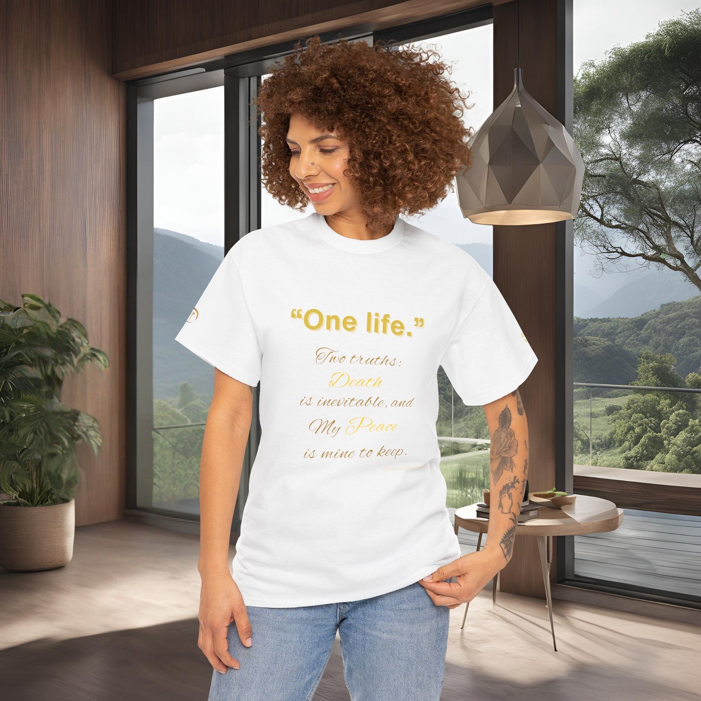 Woman wearing a white t-shirt with Essence Innovation One Life text in a modern room with large windows.