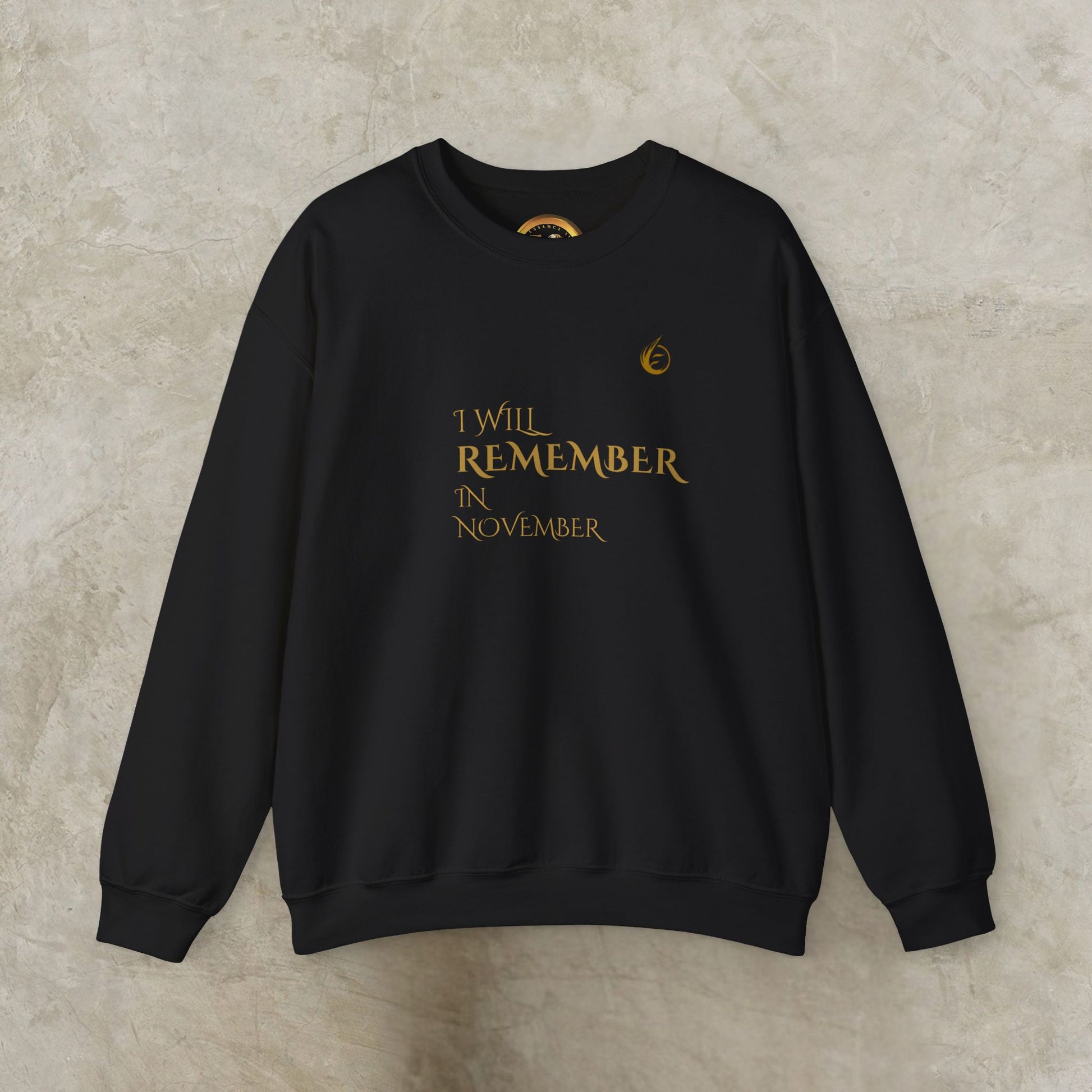 Black EssenceInnoCreate Quiet Resolve sweatshirt with gold text on a beige background