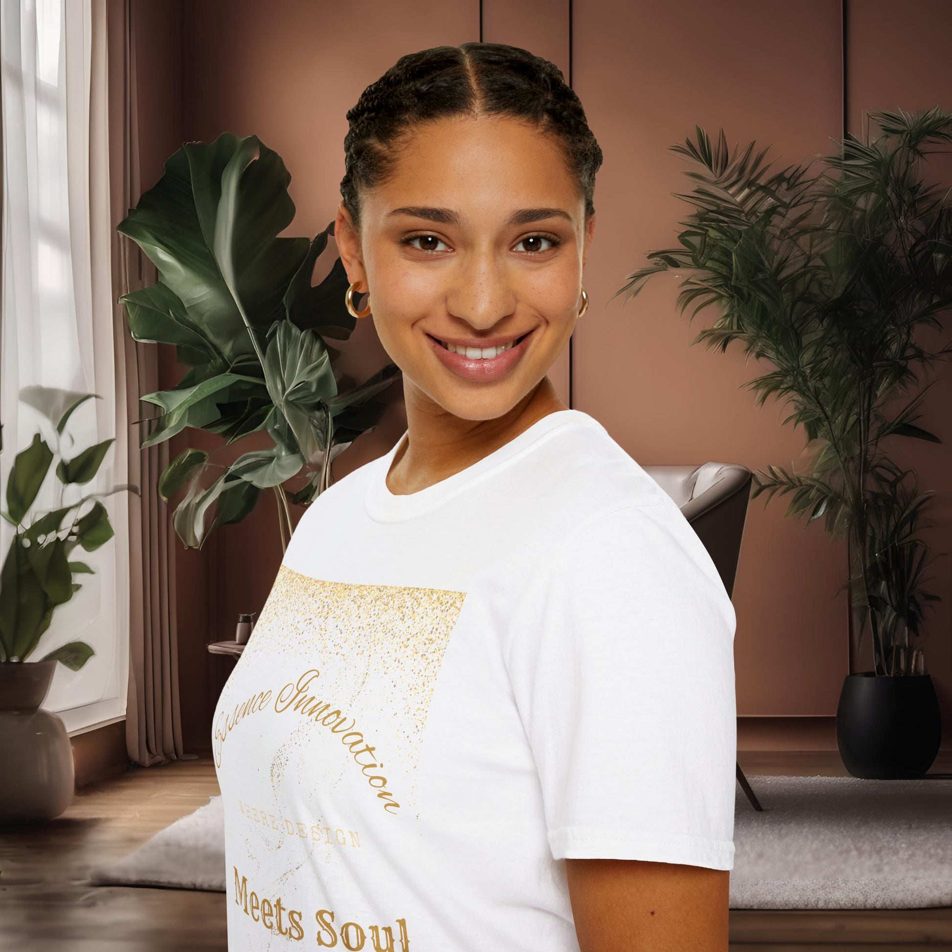 Woman wearing a white t-shirt with gold Essence Innovation 'Design Meets Soul' text in a home setting with plants