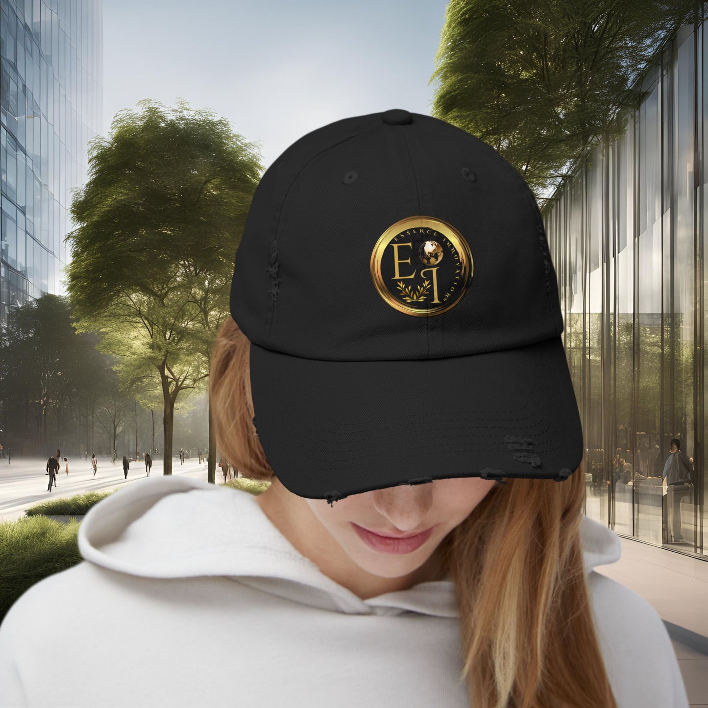 Person wearing a black Essence Innovation cap with a gold logo in an urban setting
