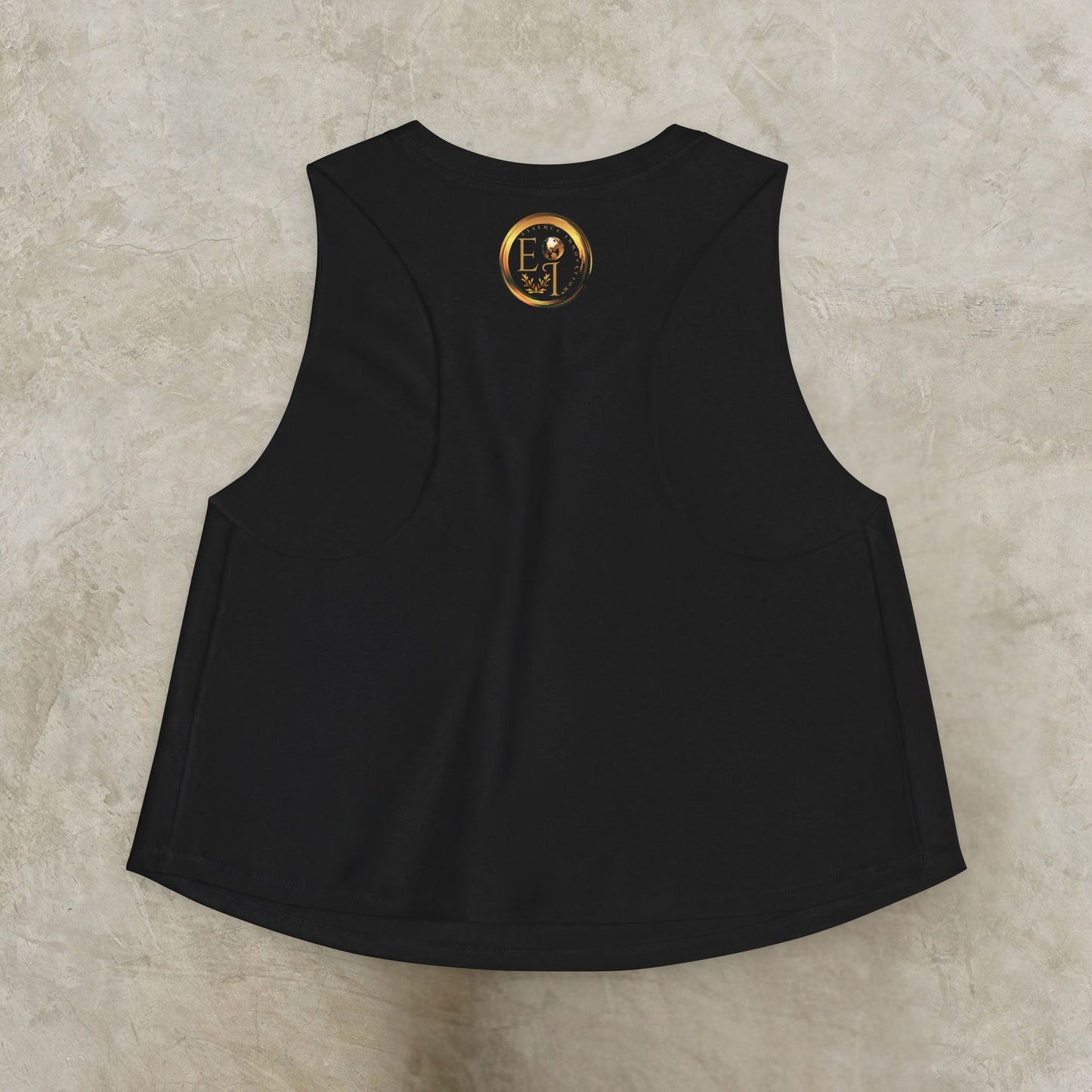 Black sleeveless shirt with Essence Innovation logo on the back against a beige background
