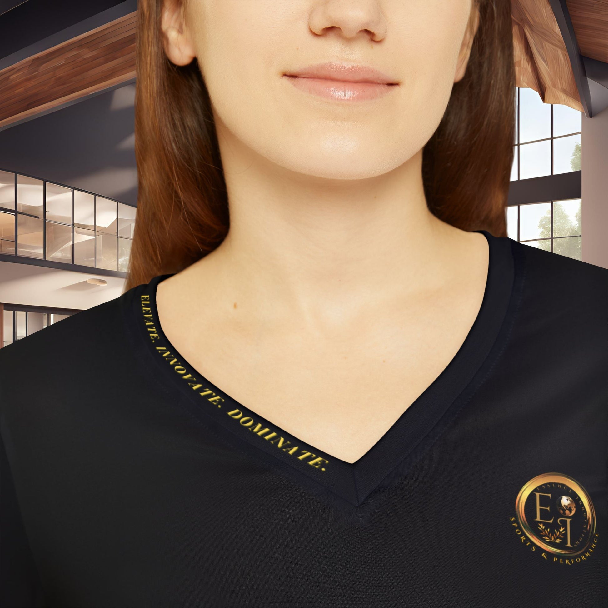 Person wearing a black Essence Innovation Seek More shirt with gold text and logo