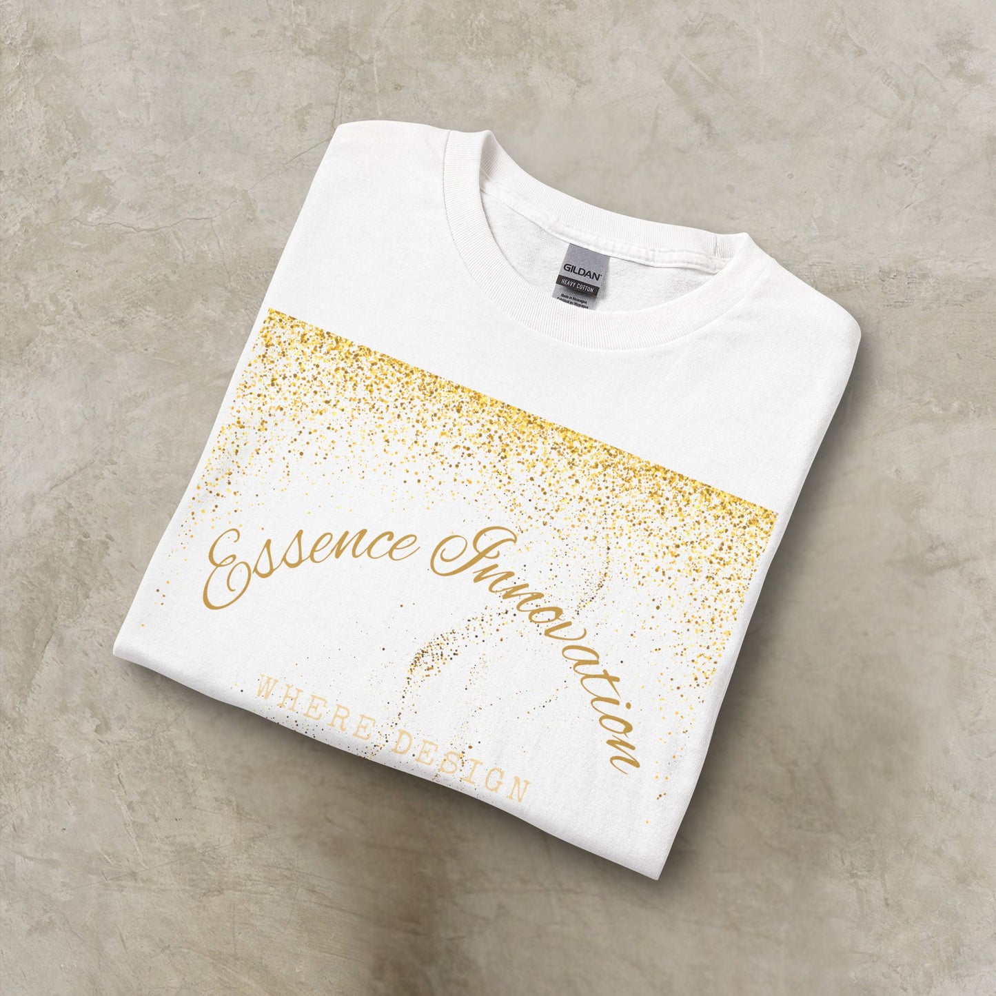 Folded white t-shirt with gold Essence Innovation 'Design Meets Soul' text on a gray surface