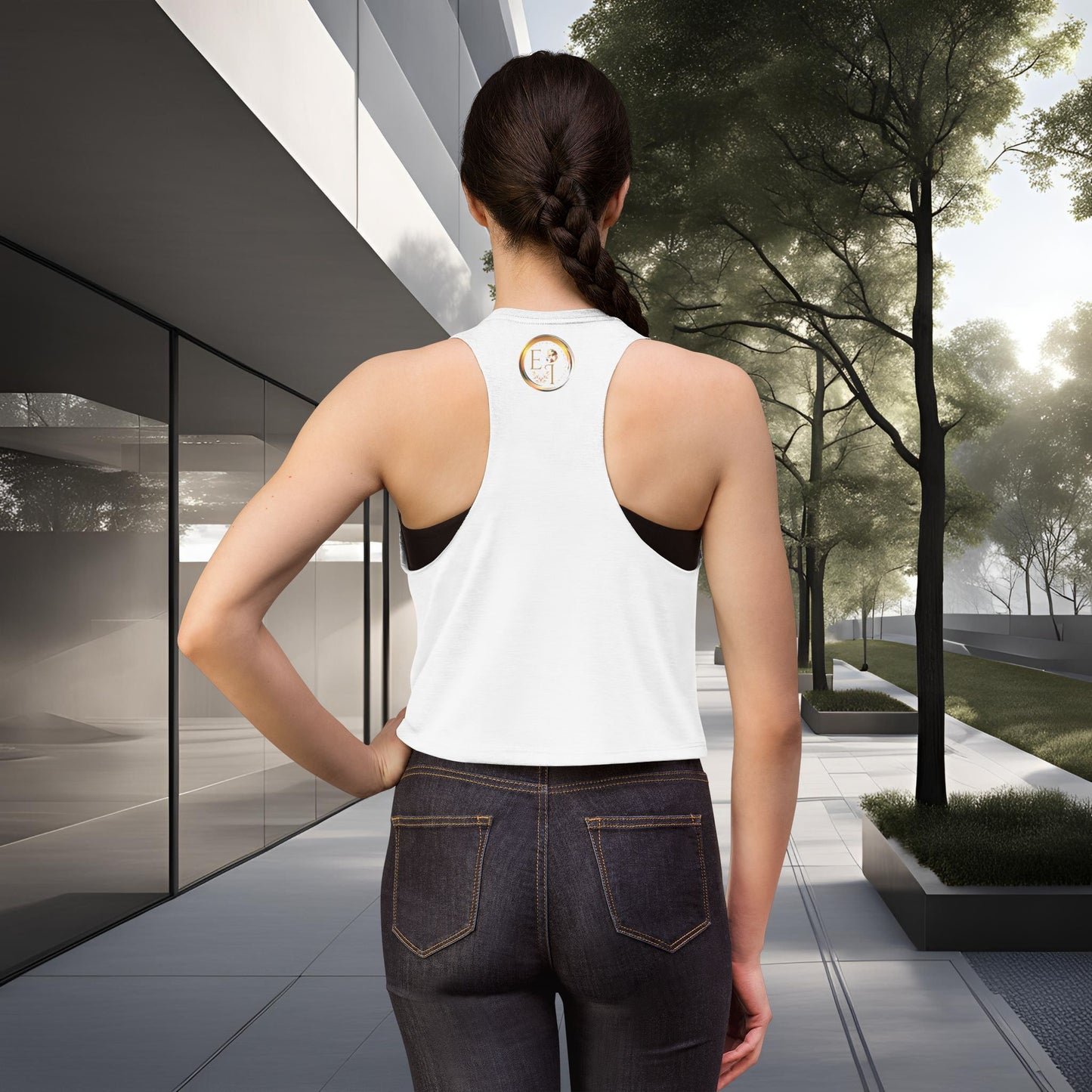 Person wearing a white tank top with a Essence Innovation logo, standing in an outdoor setting.