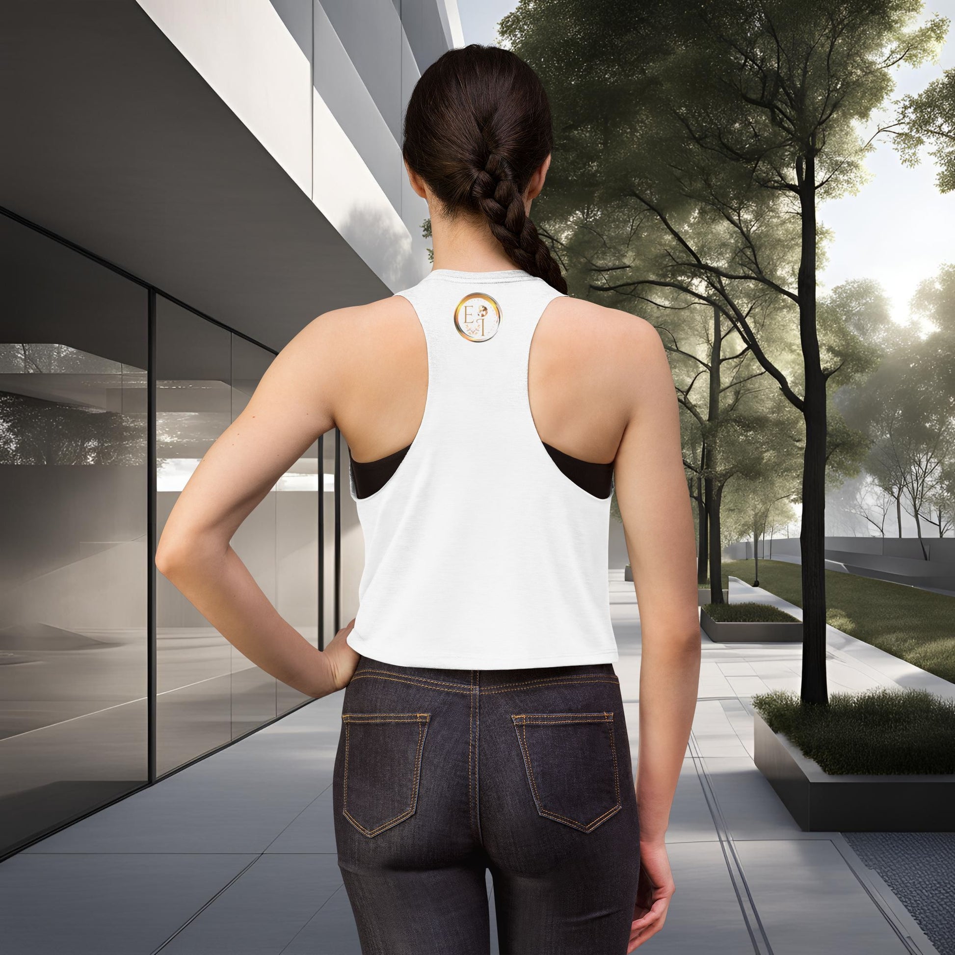 Person wearing a white tank top with a Essence Innovation logo, standing in an outdoor setting.