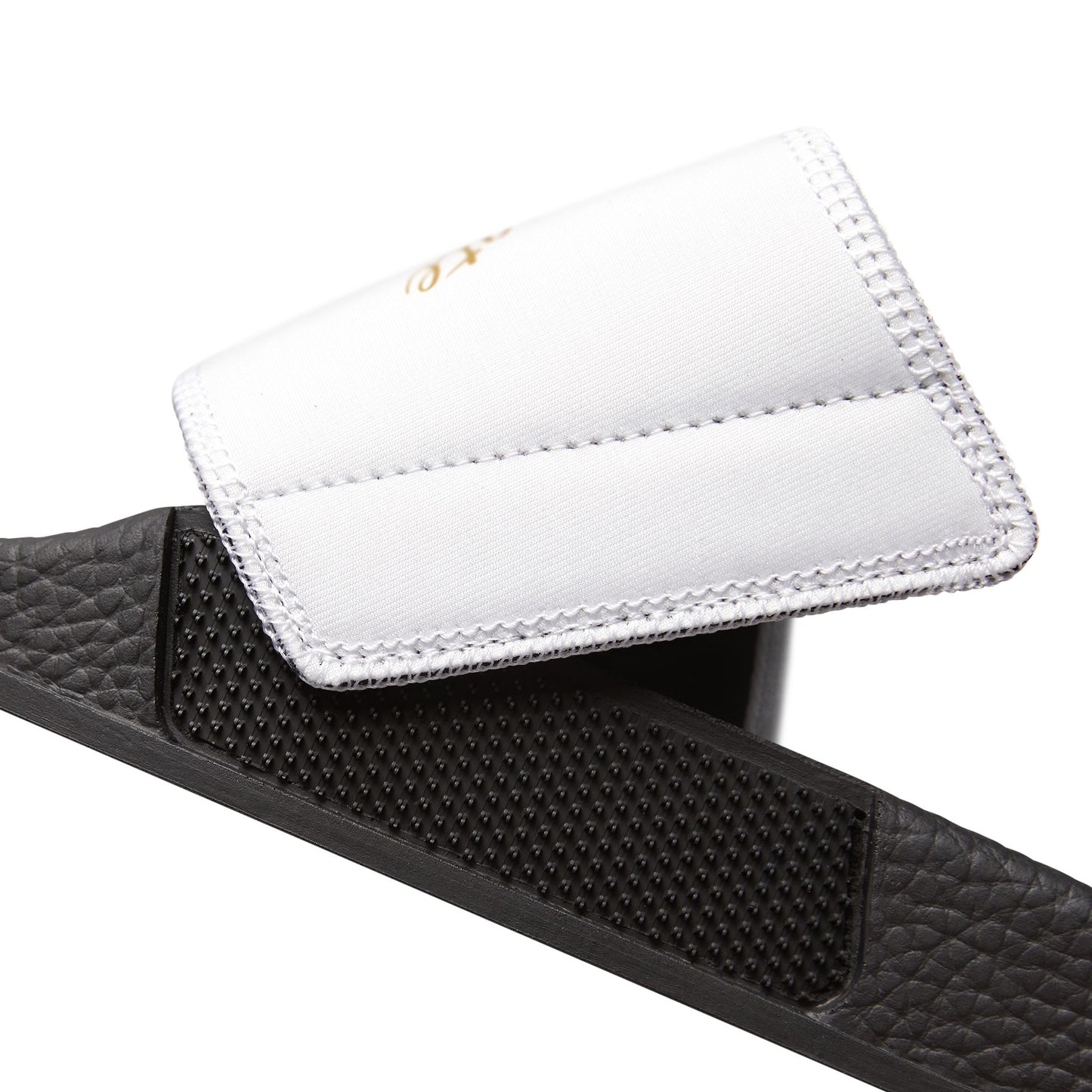 Black EssenceInnoCreate slide sandal with a white insole on a white background