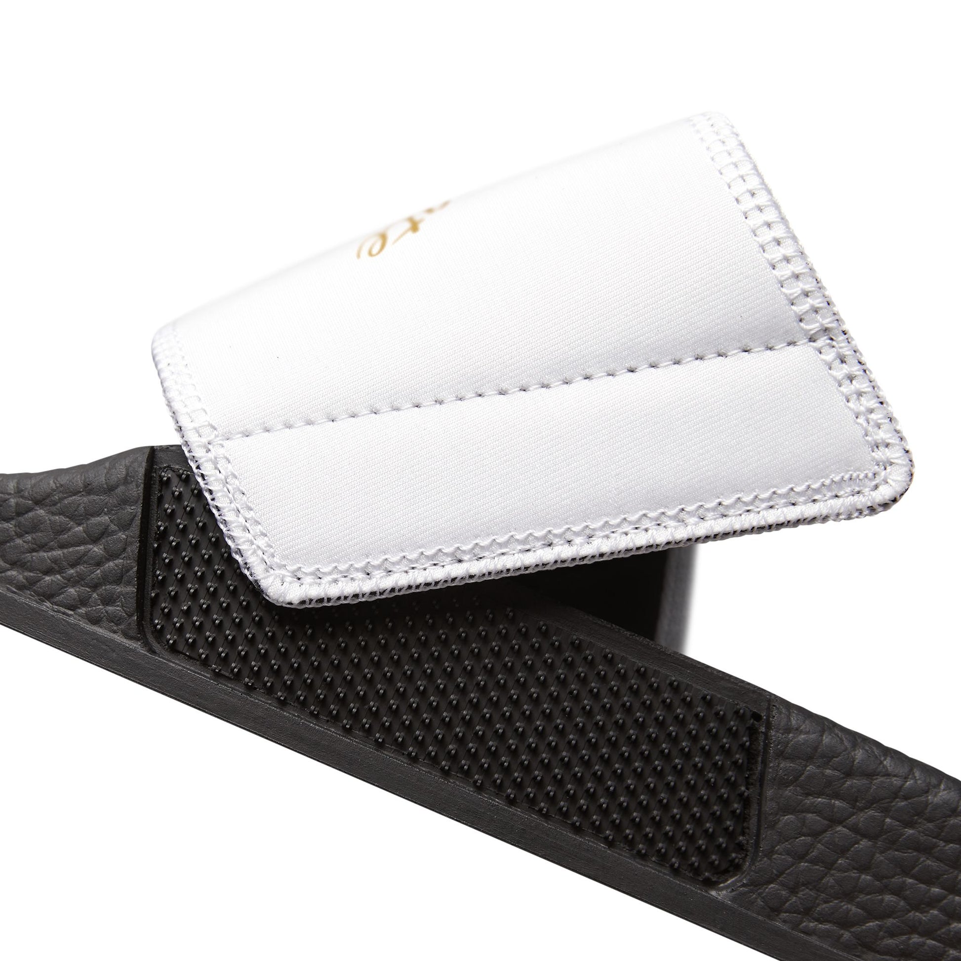 Black EssenceInnoCreate slide sandal with a white insole on a white background