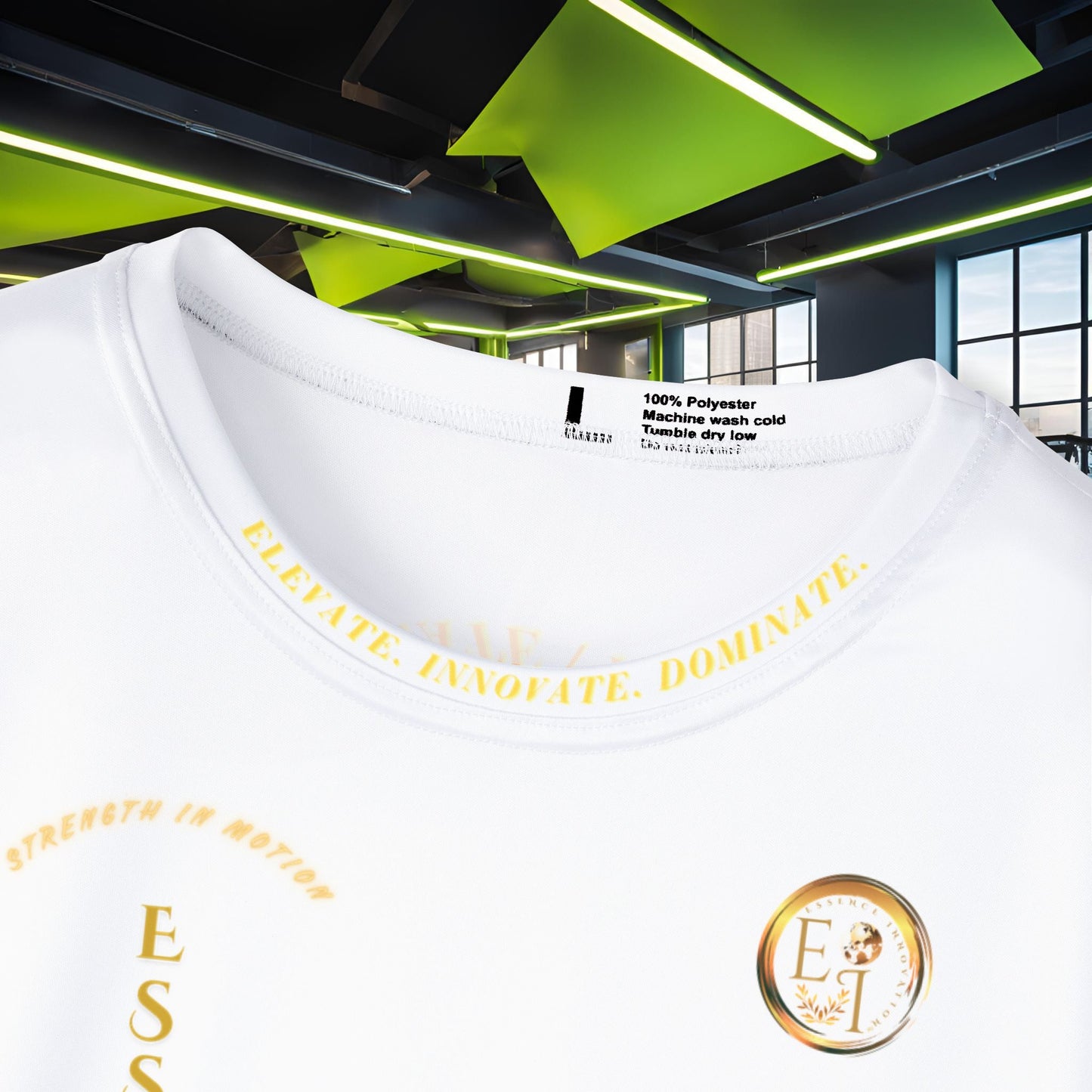 White t-shirt with yellow Essence Innovation Elevate, Innovate, and Dominate text and branding in a modern indoor setting